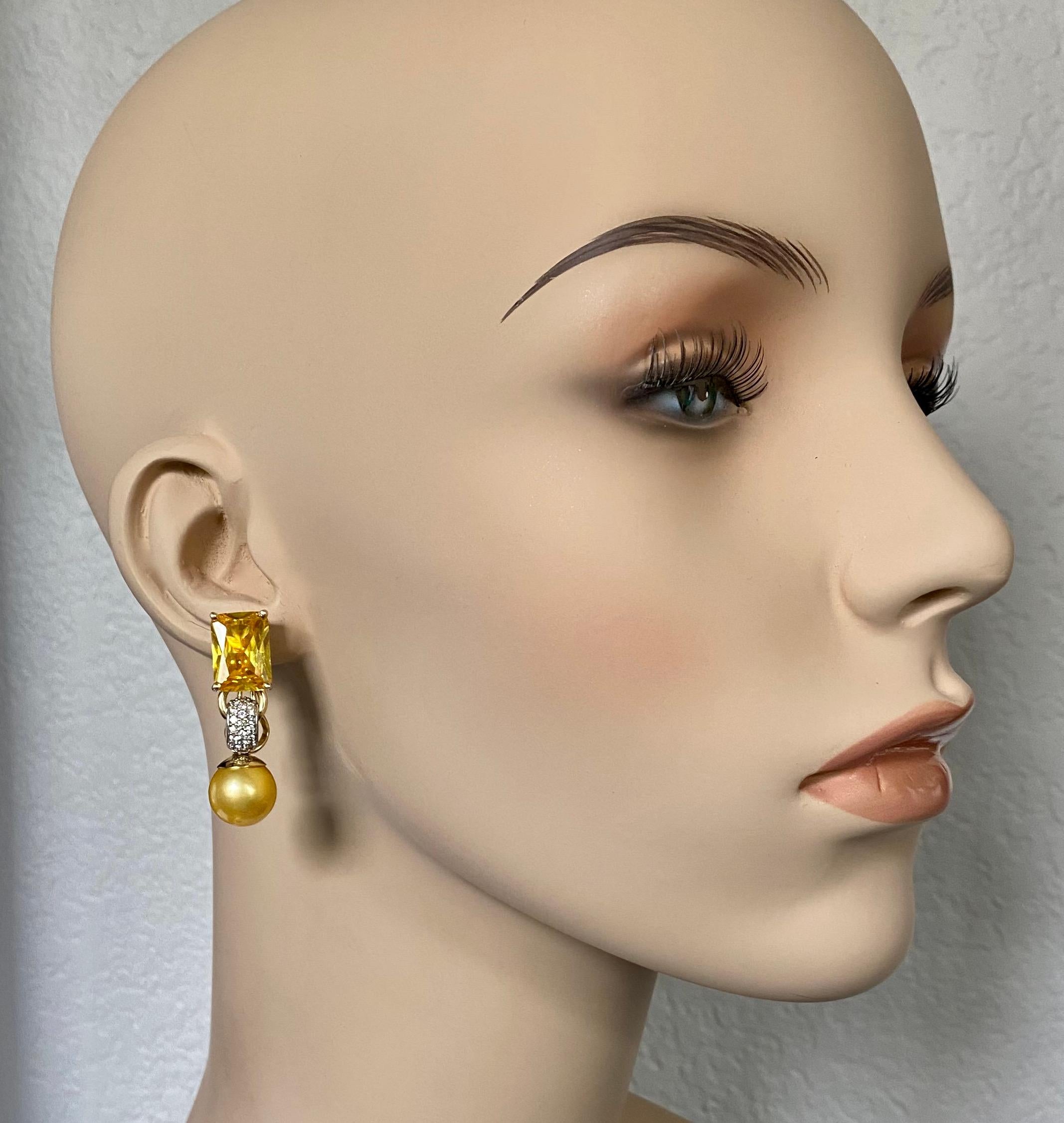 Golden beryl is paired with golden South Seas pearls in this sophisticated dangle earrings.  Golden beryl (origin: Brazil) is part of a large family of gems including aquamarine, Morganite (pink), emerald and chrysoberyl cat's eye.  The stones are