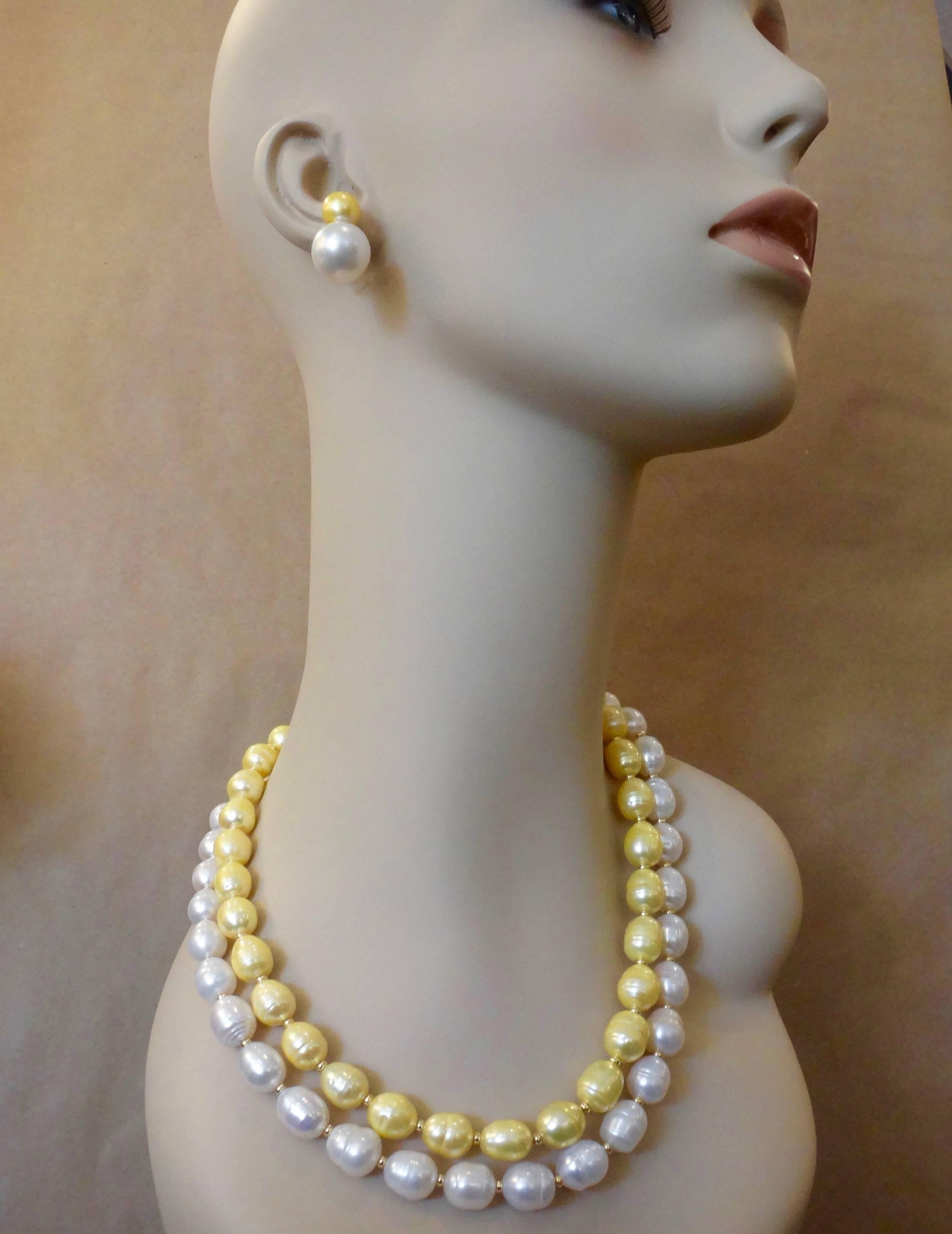 Two strands of perfectly conformed baroque circle pearls shape this daring and impressive necklace.  The outer strand of pearls are bright white.  The inner strand of pearls are in lovely shades of gold.  Both have great luster.  The strands are