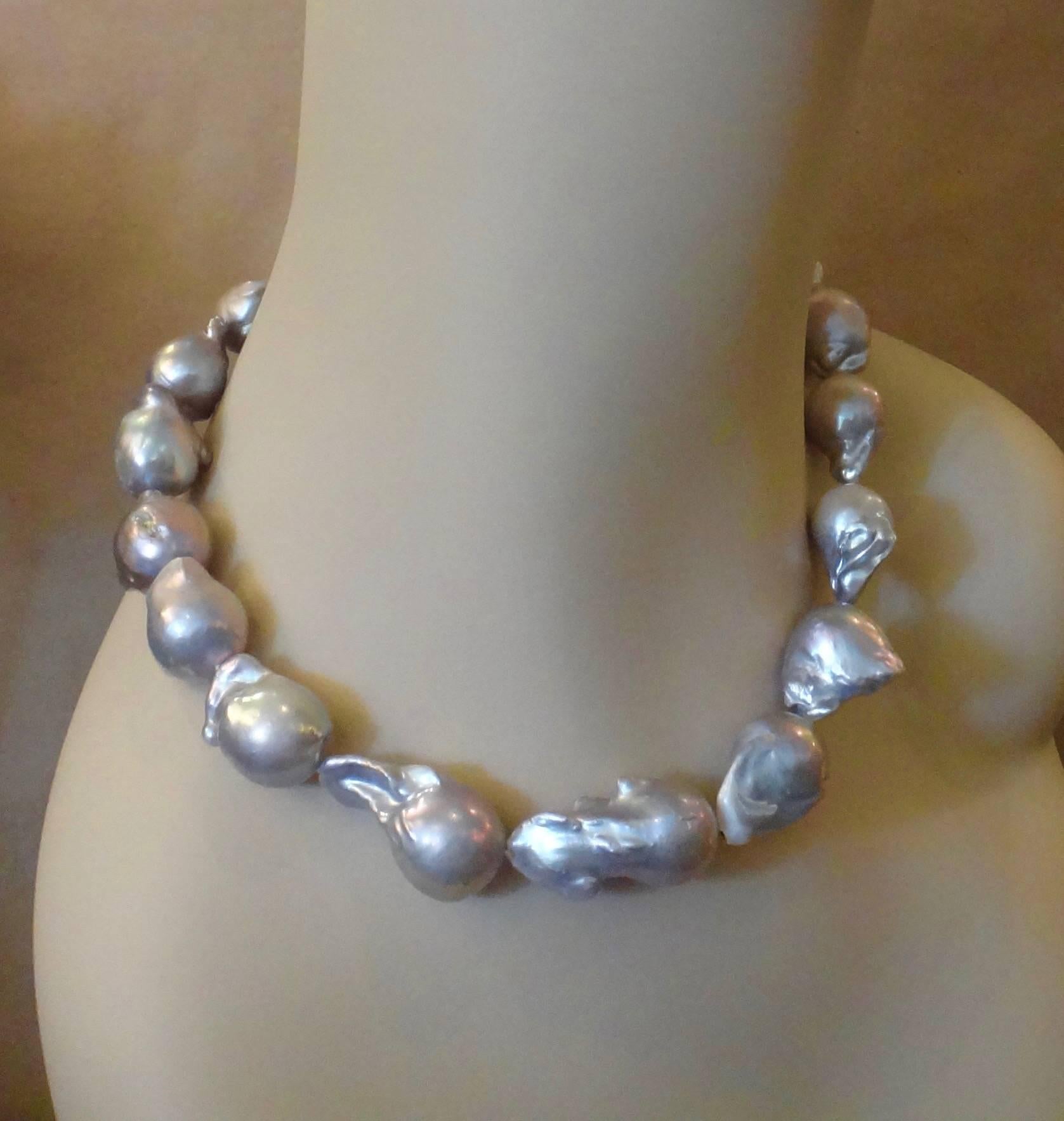 Eighteen ginormous gray baroque freshwater pearls make up this eighteen inch necklace.  The pearls graduate in size from approximately 18 x 20mm to a huge 23 x 35mm.  The rare gray body color has lovely undertones of pink and green and the pearls