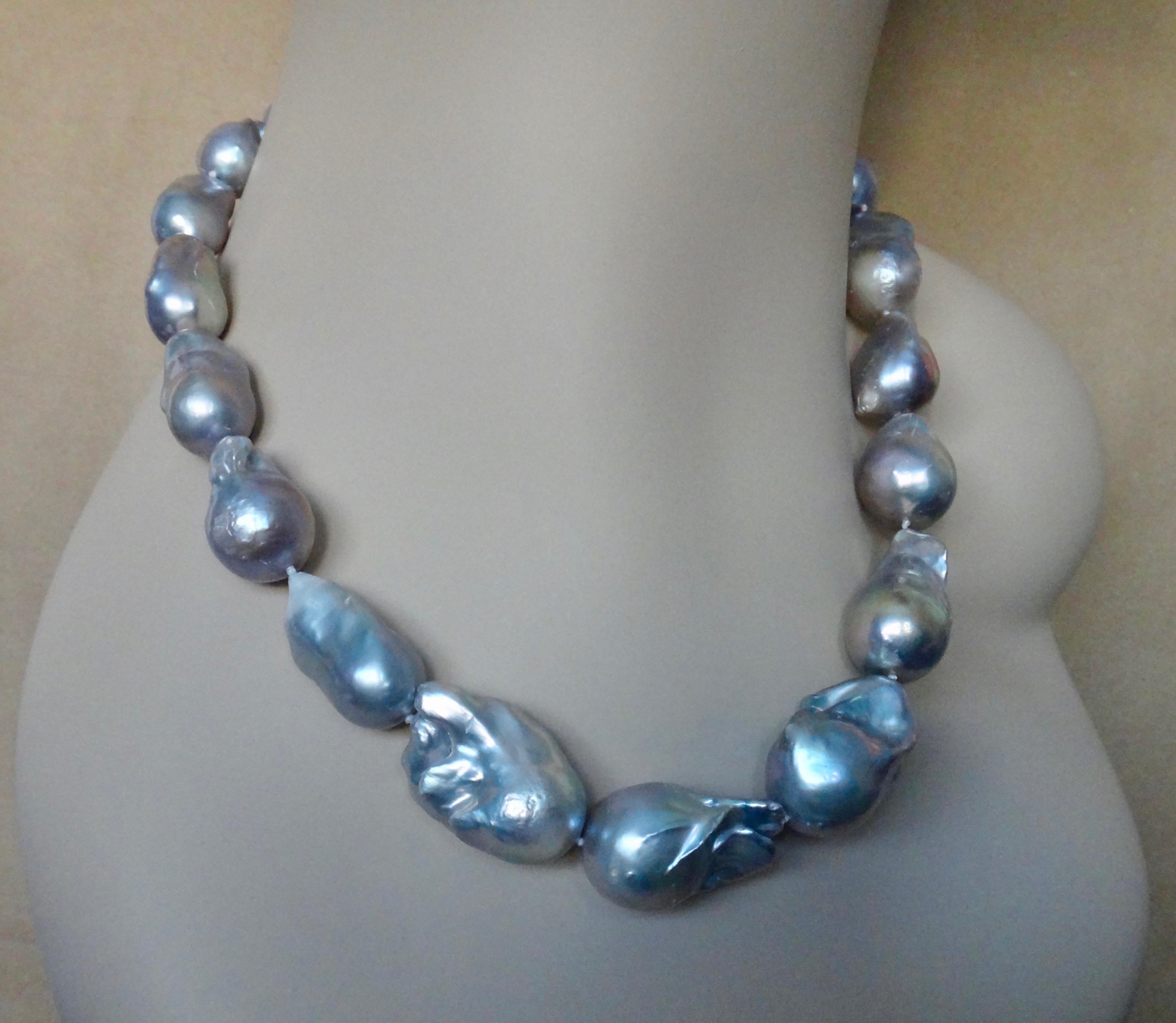 Eighteen ginormous gray baroque pearls comprise this bold and versatile necklace.  The pearls graduate in size from approximately 18 x 20mm to a huge 23 x 35mm.  The rare gray body color has lovely pinkish undertones.  The pearls possess great