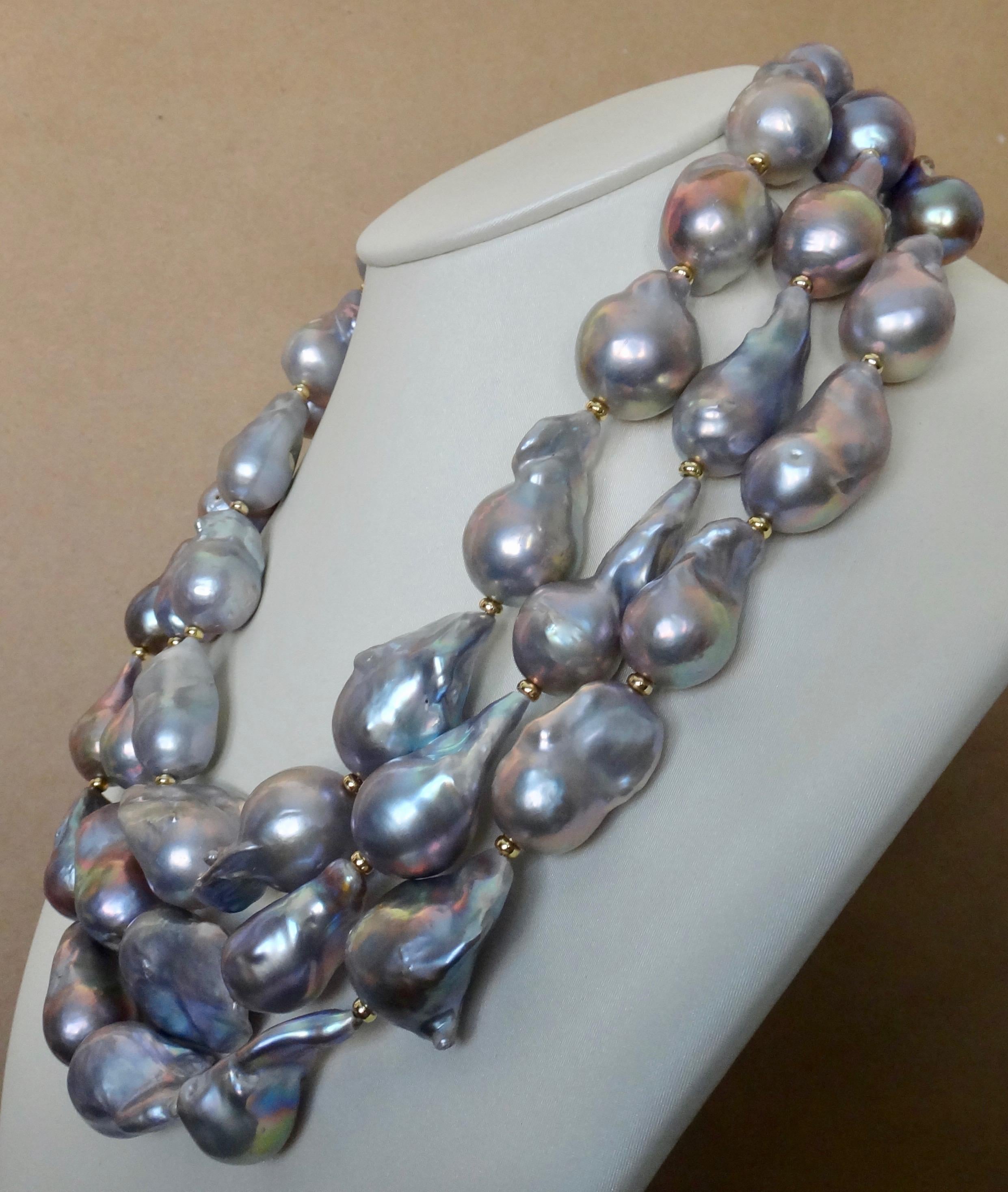  Baroque gray pearls in three graduated strands comprise this sensational necklace.  The 45 pearls range in size from 23mm to a gargantuan size of 31mm.  All the baroque pearls are highly lustrous and reflect a range of colors from shades of blues,