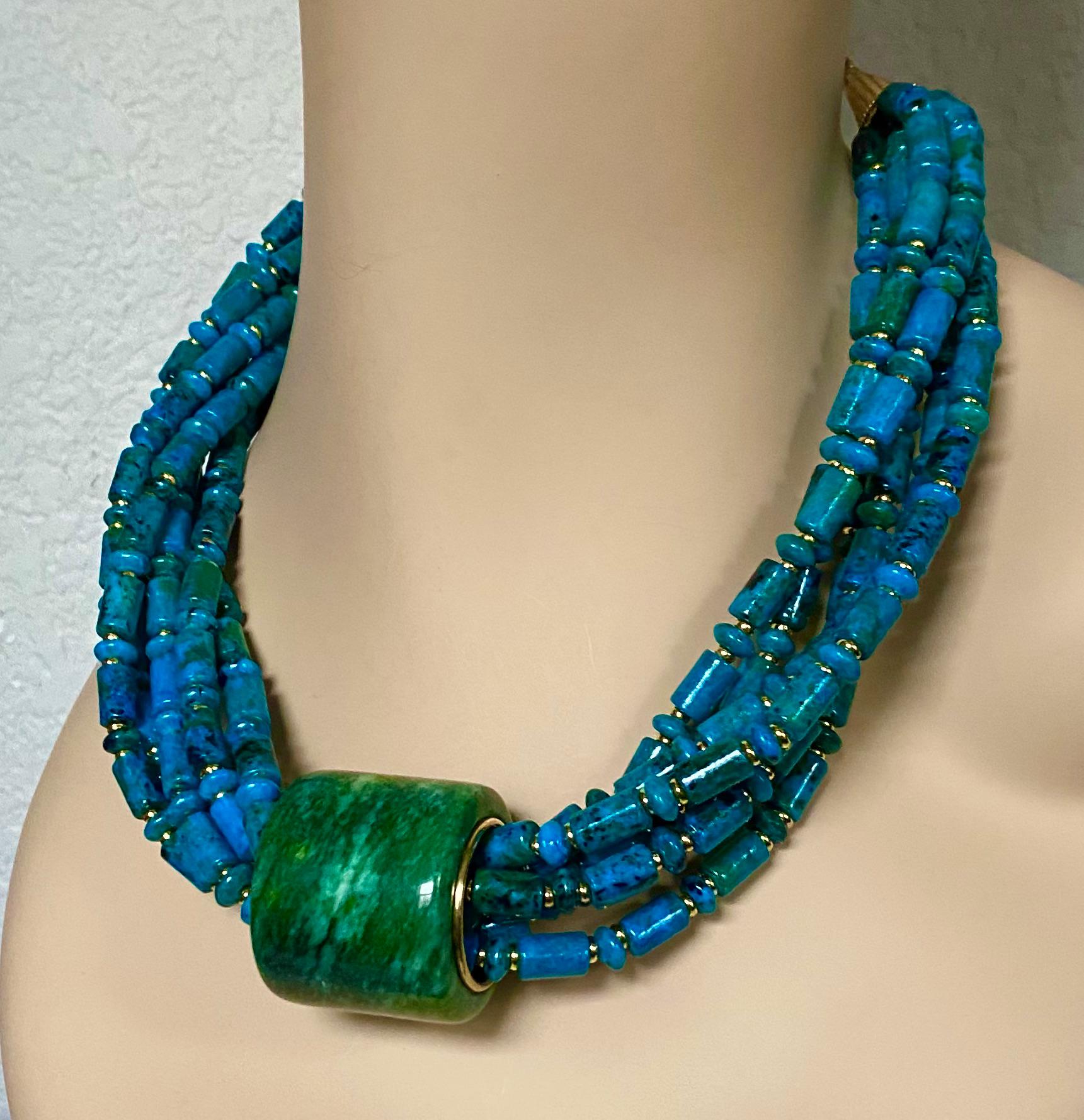 A jadeite archer's ring is the centerpiece of this dramatic torsade necklace.  Jadeite (origin: Myanmar) is the supreme member of the larger jade family.  It is valued for its range of colors, hardness and durability.  Jadeite polishes to a
