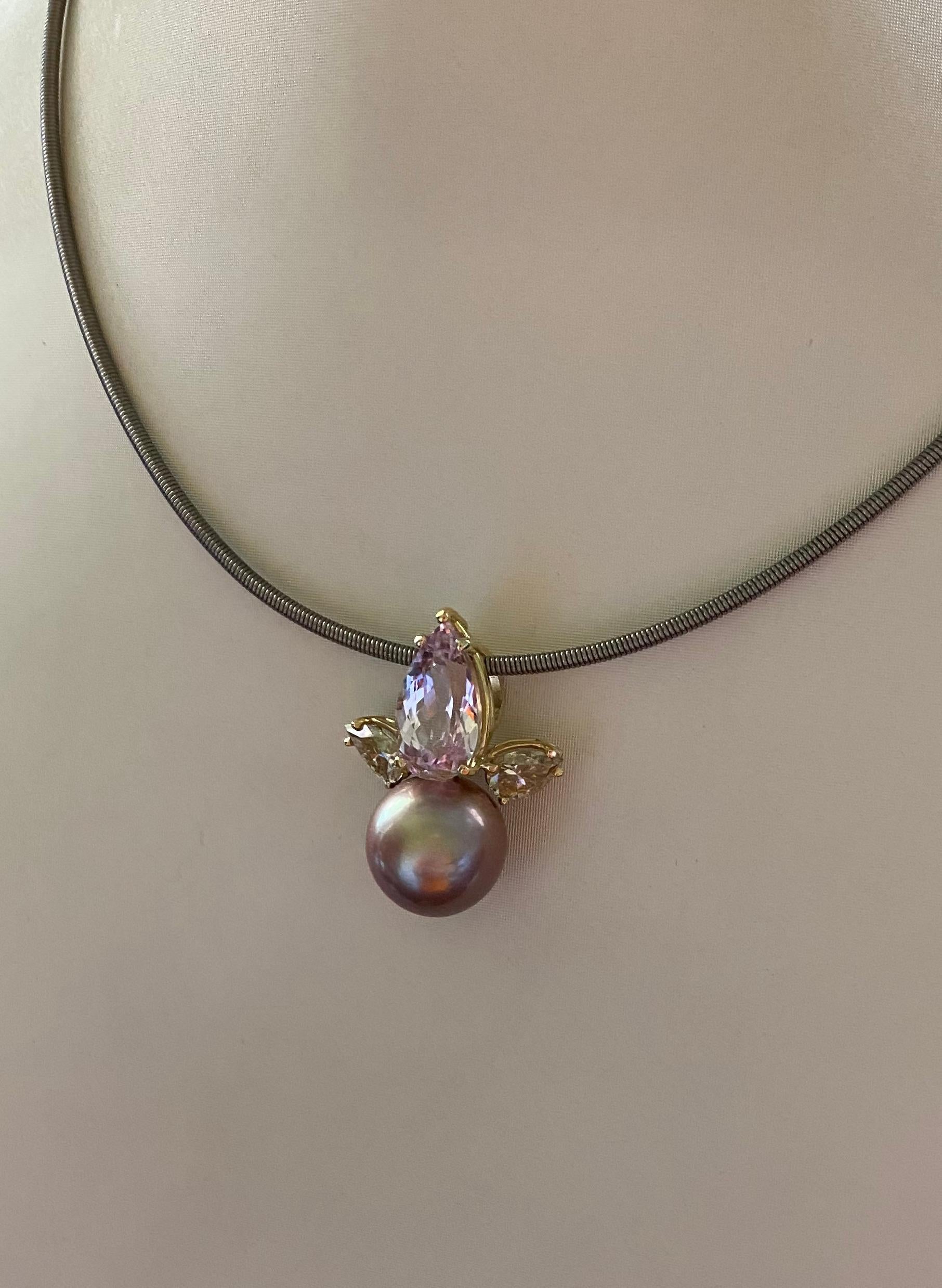 Kunzite, Tahitian pearl and champagne diamonds are showcased in this elegant pendant.  The kunzite (origin: Brazil) is a delicate orchid pink and fashioned as an elongated pear shape.  The gem is well cut and polished.  The kunzite is complimented