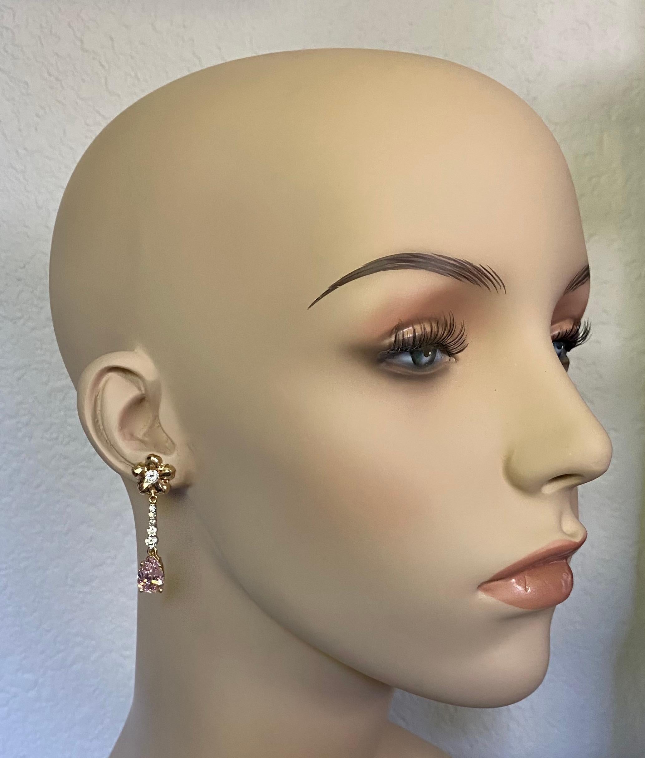 Kunzite is featured in those dainty dangle earrings. Kunzite (origin: San Diego County, California) is the best known member of the spodumene family of gems.  It is revered for its delicate pink color.  The exceptionally well cut pear shapes are