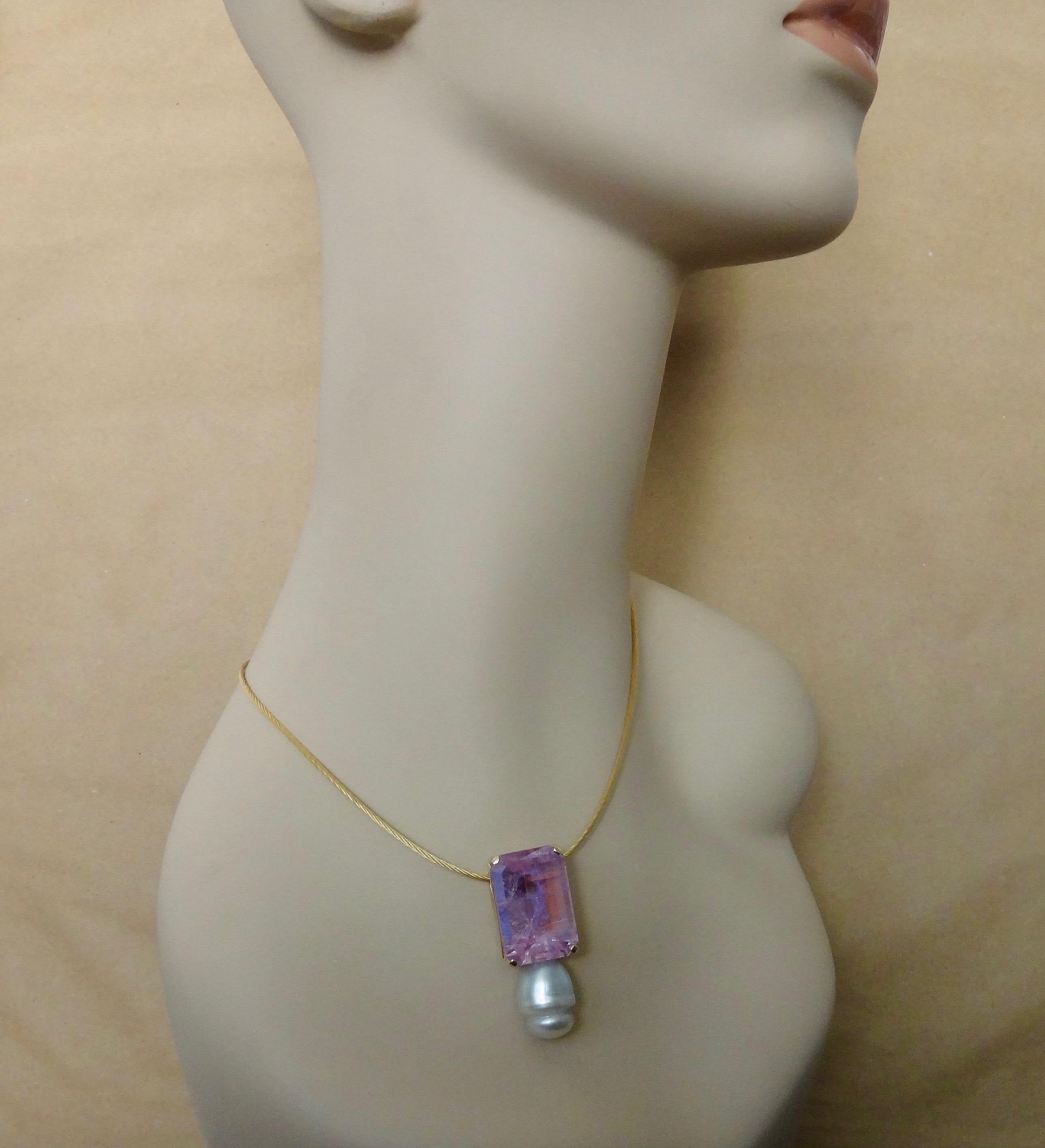 Kunzite (origin: Brazil) is the centerpiece of this impressive drop pendant.  Kunzite is a member of the spodumene family of gems.  This stone weighs 76.55 carats.  The gem is known for it's pink-violet color.  This specimen is polished to a mirror