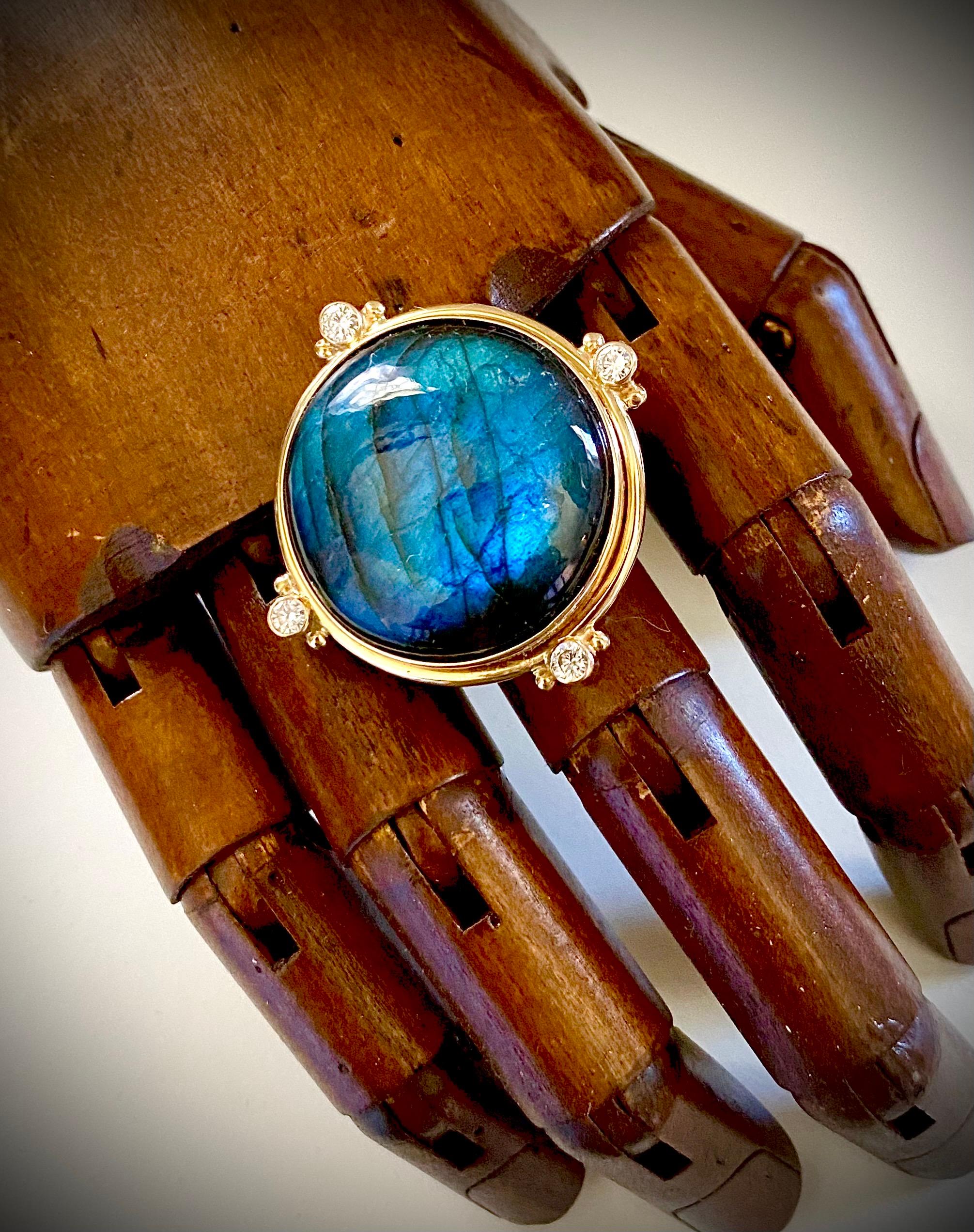 Labradorite is featured in this bold archaic style ring.  Labradorite was first discovered in the late 1700's in Labrador, Canada.  According to Eskimo legend, the northern lights were freed from labradorite.  This exceptional example is from