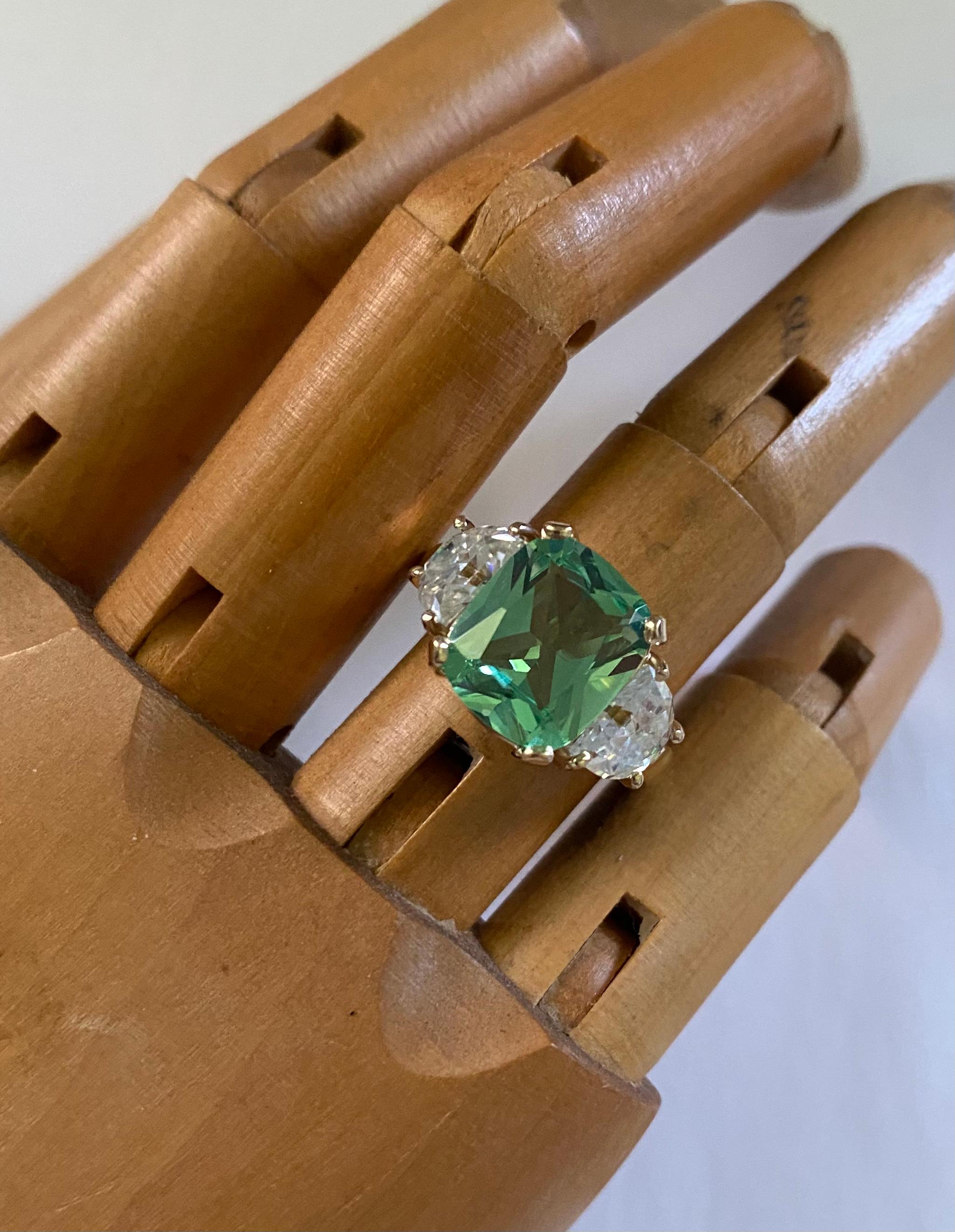 Merelani mint garnet is featured in this classic three stone ring.  Merelani garnet is named after its mining location, the Merelani Hils of Tanzania.  Like Tsavorite Garnets, they are a form of Grossular Garnet.  Both garnet types are found in the