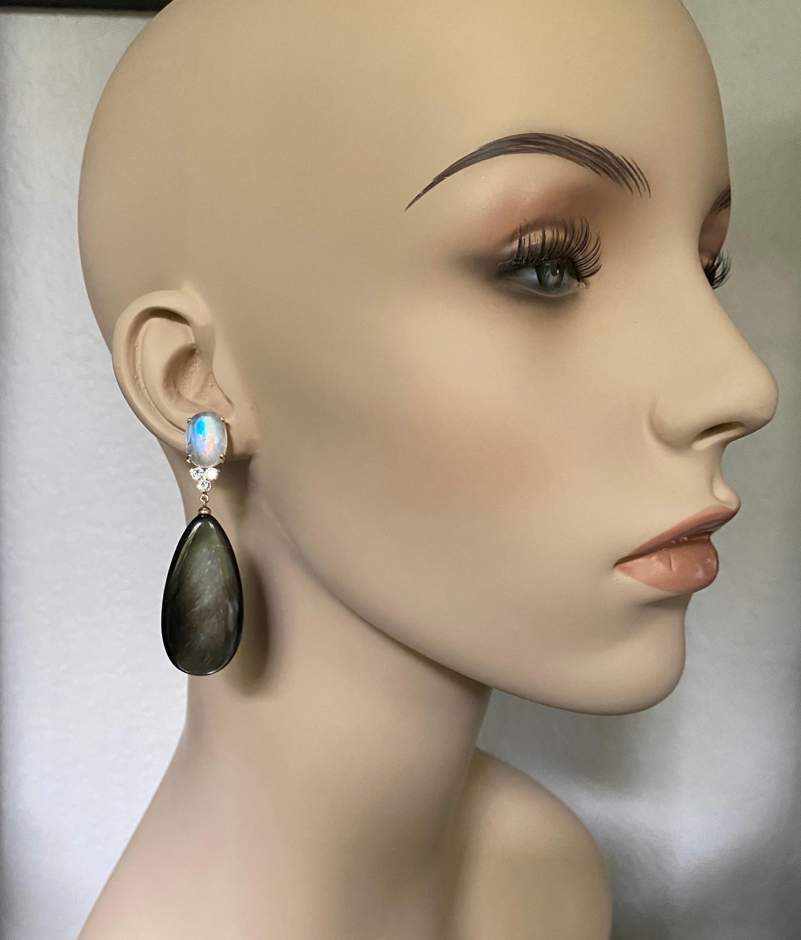 Moonstone is paired with black mother-of-pearl in these elegant dangle earrings.  The moonstones (origin: India) are referred to as 