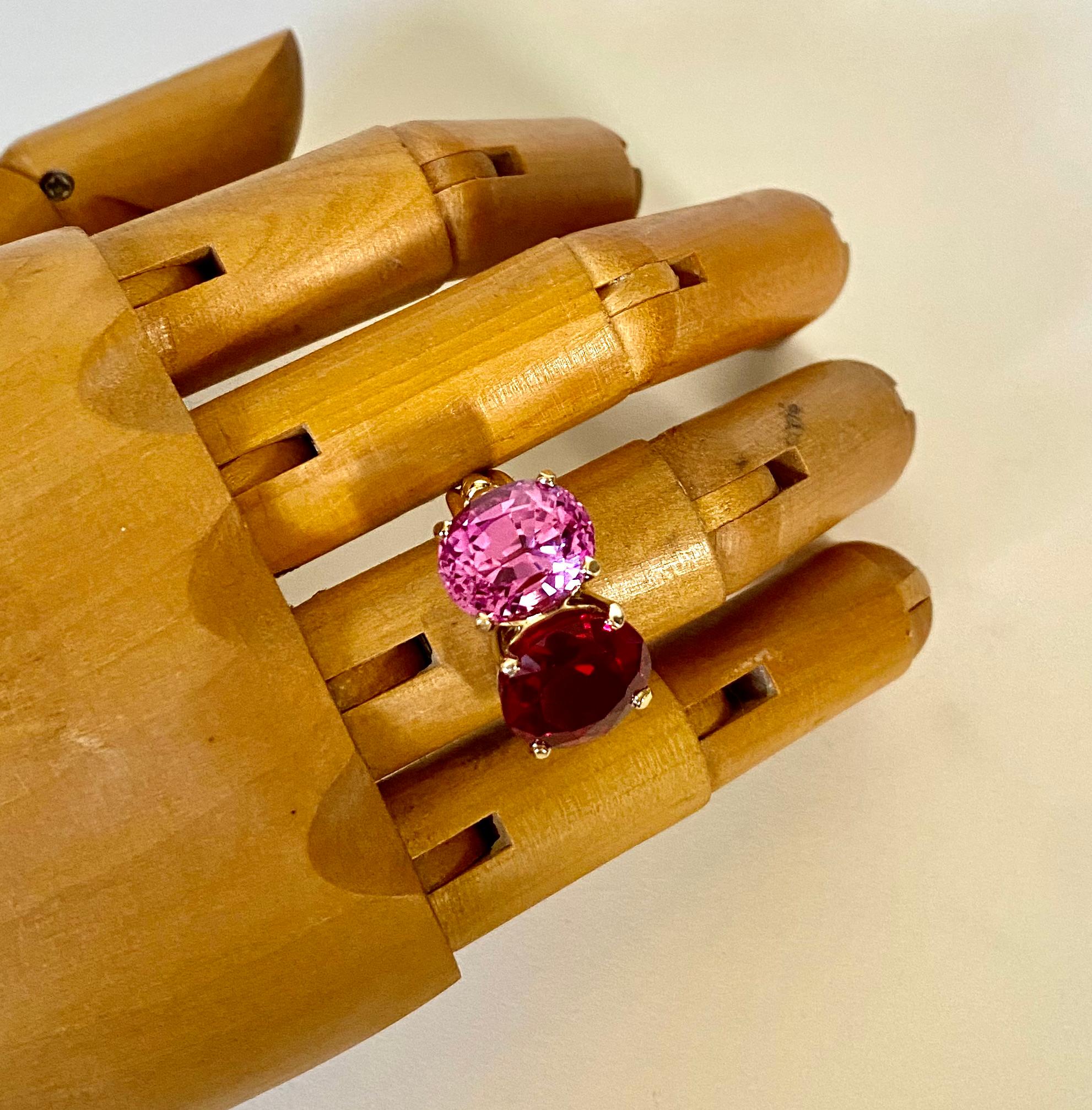 Pink topaz is paired with Mozambique garnet in this elegant Due Pietra ring.  The gems are a highly complimentary color combination.  They are well matched in size and both are expertly cut and polished.   The design for the mounting harkens back to