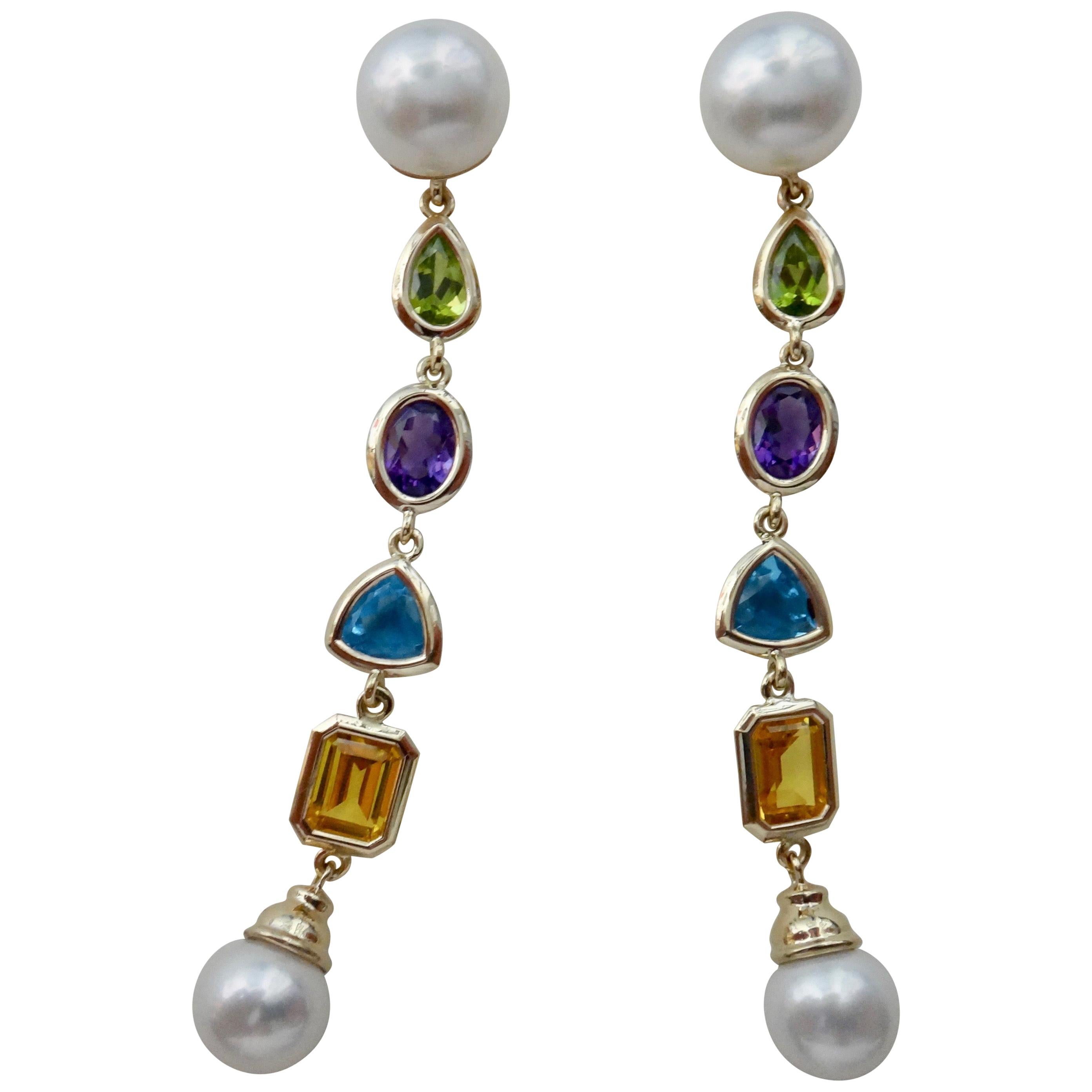 Offered are these one-of-a-kind dangle earrings consisting of pear shaped peridot, oval shaped amethyst, trillion cut blue topaz and emerald cut citrine.  The earrings begin and end with gem quality Paspaley South Seas pearls (origin: Australia). 