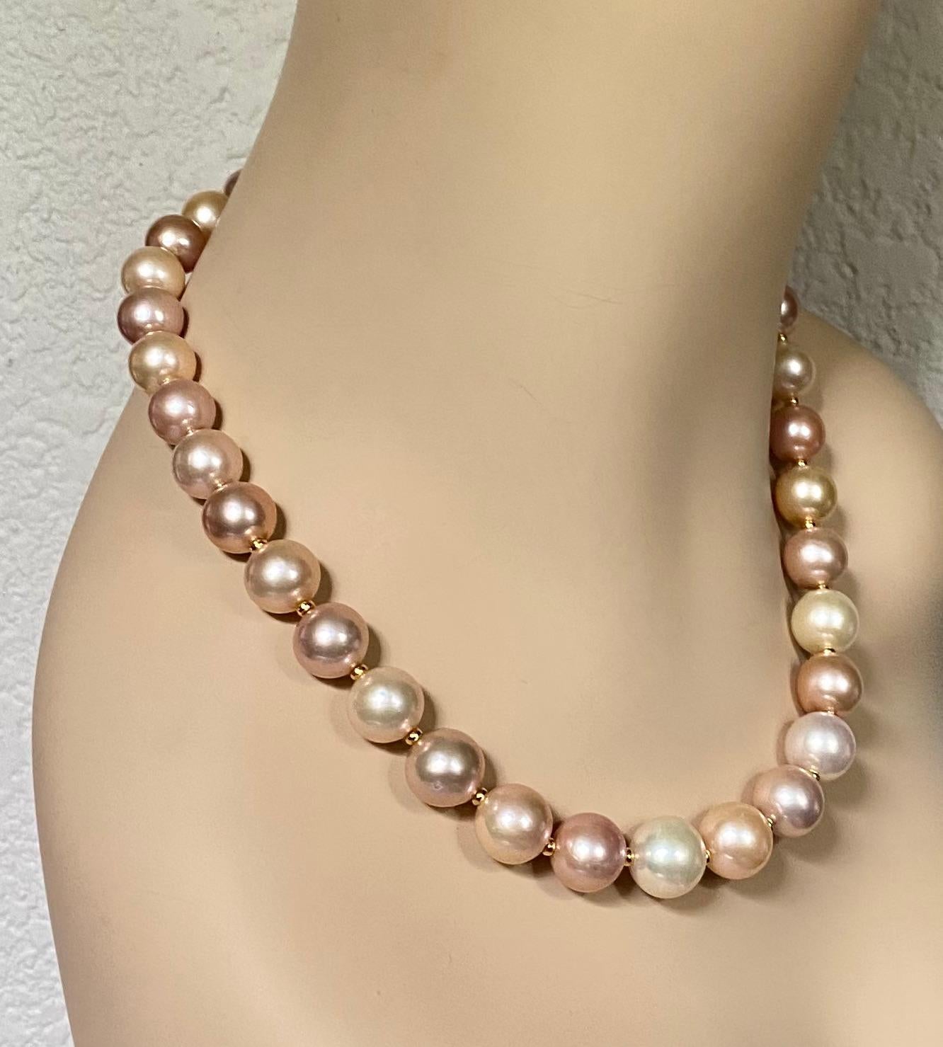 Gem quality freshwater pearls are showcased in this elegant necklace.  Thirty two pearls graduate in size from the largest at 14mm to the smallest at 12mm.  They possess rich luster and are blemish free.  The pearls are in shades and tones of cream,