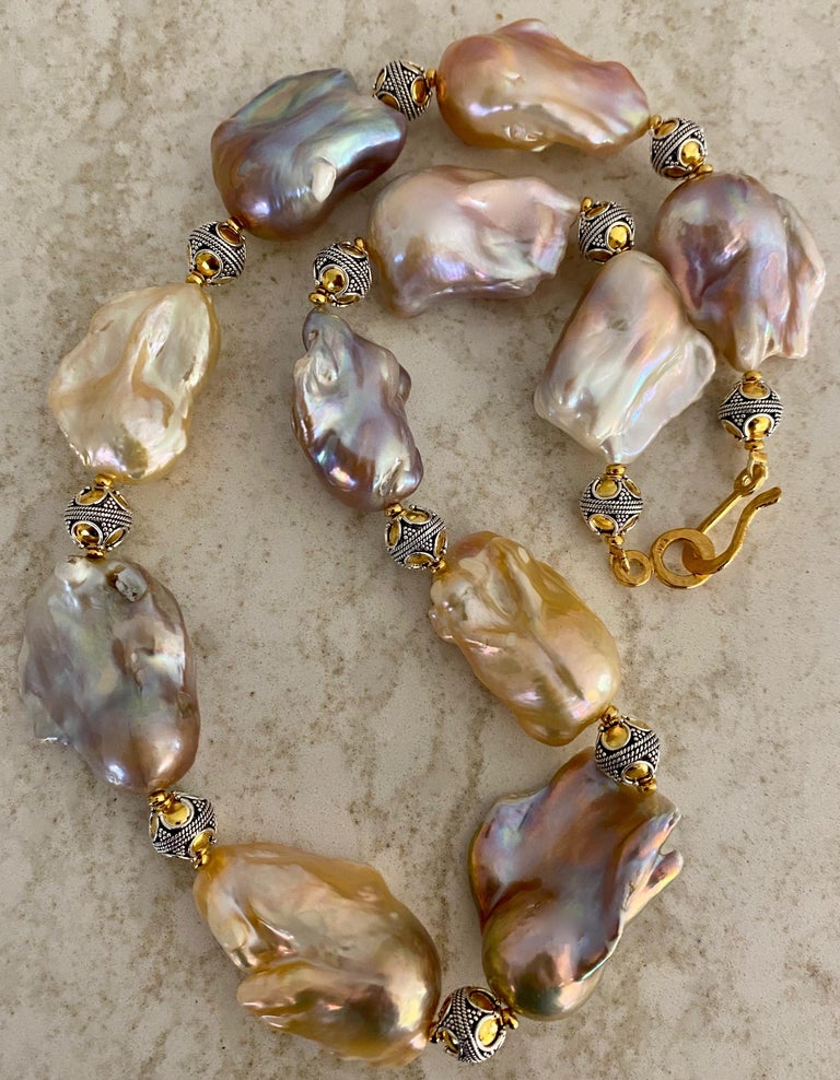 Eleven ginormous baroque pearls (origin: China) form this statement necklace.  The pearls are in shades of peach, lavender, gray and pink.  They are blemish free and possess highly reflective nacre.  The largest pearl measures 1 inch by 1 7/8 inches