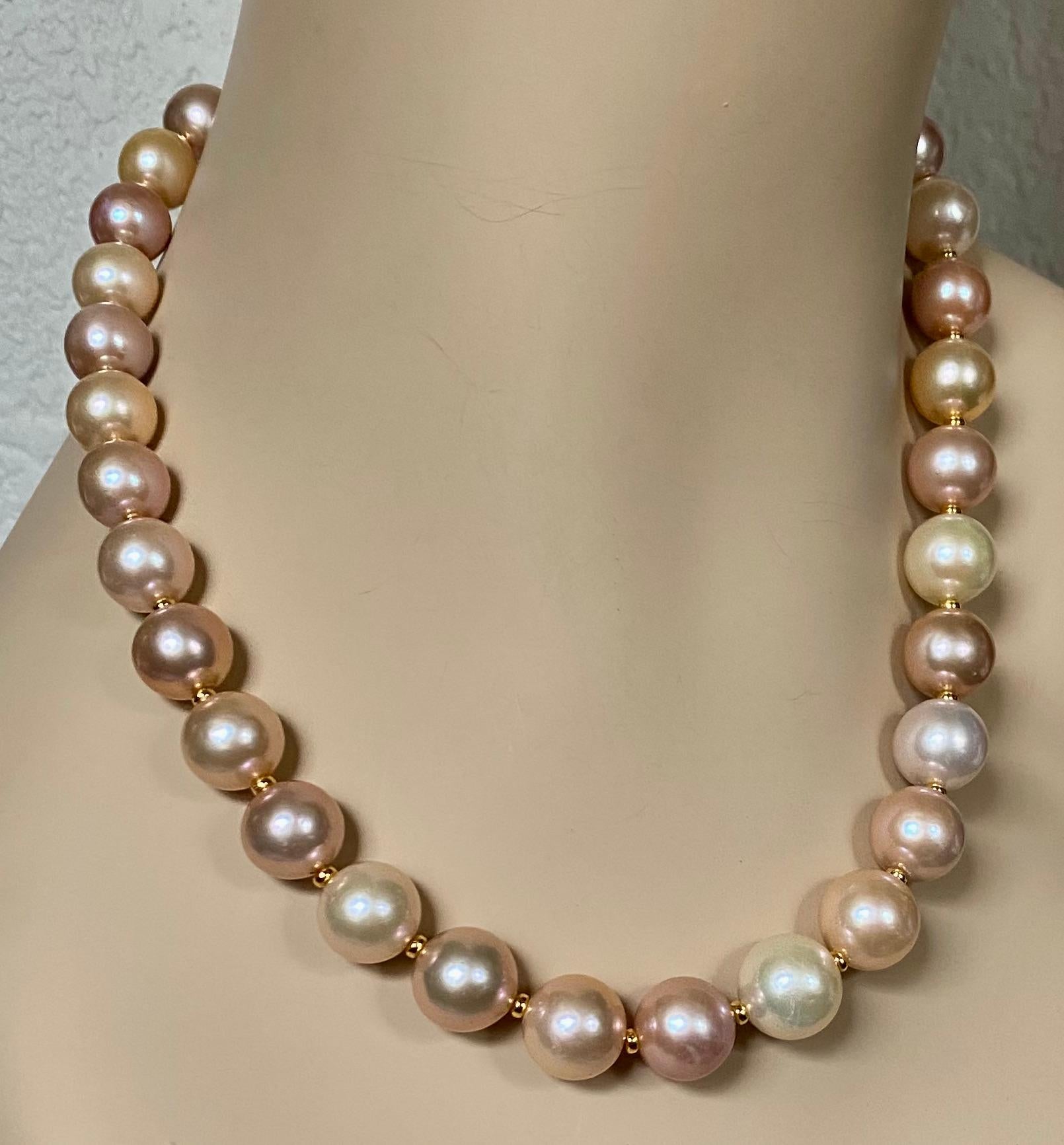 Freshwater pearls in shades of peach, lavender, cream and pink are mixed together to create this superb necklace.  Thirty two huge pearls (origin: China) are slightly graduated in size from 12.5mm (1/2 inch) to 14.5mm (5/8 inch).  They are blemish