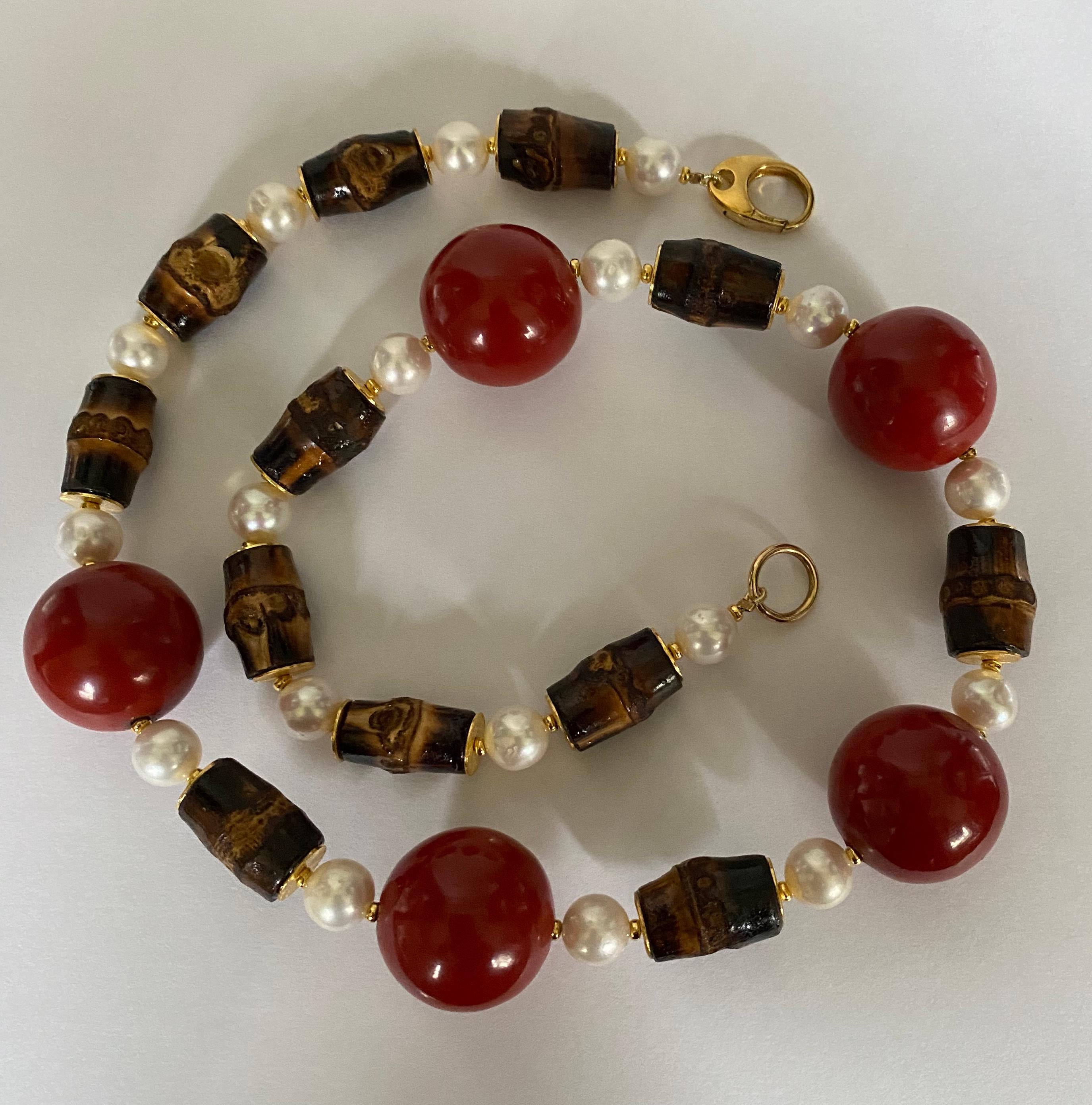 Cinnabar lacquered wood beads are showcased in this bold  necklace.  Cinnabar is a mineral ground to a fine powder and mixed with resin (sap) from pines trees found in southern China.  The process is tedious as the material takes days to cure and