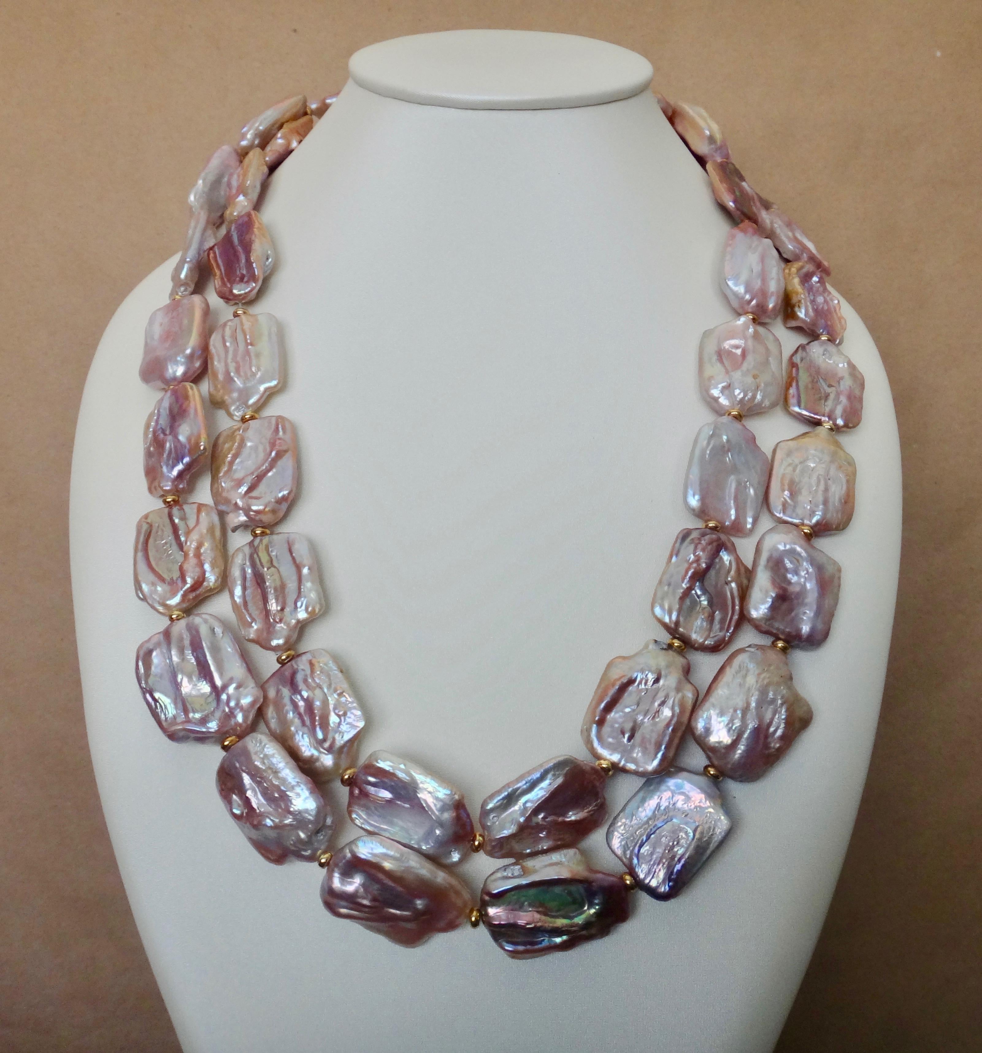 One long strand of pink tile pearls makes this a very versatile and easy to wear necklace.  The pearls average one inch by one inch in size.  They have a highly reflective, almost metallic luster and a dramatic range of colors from pale pink to