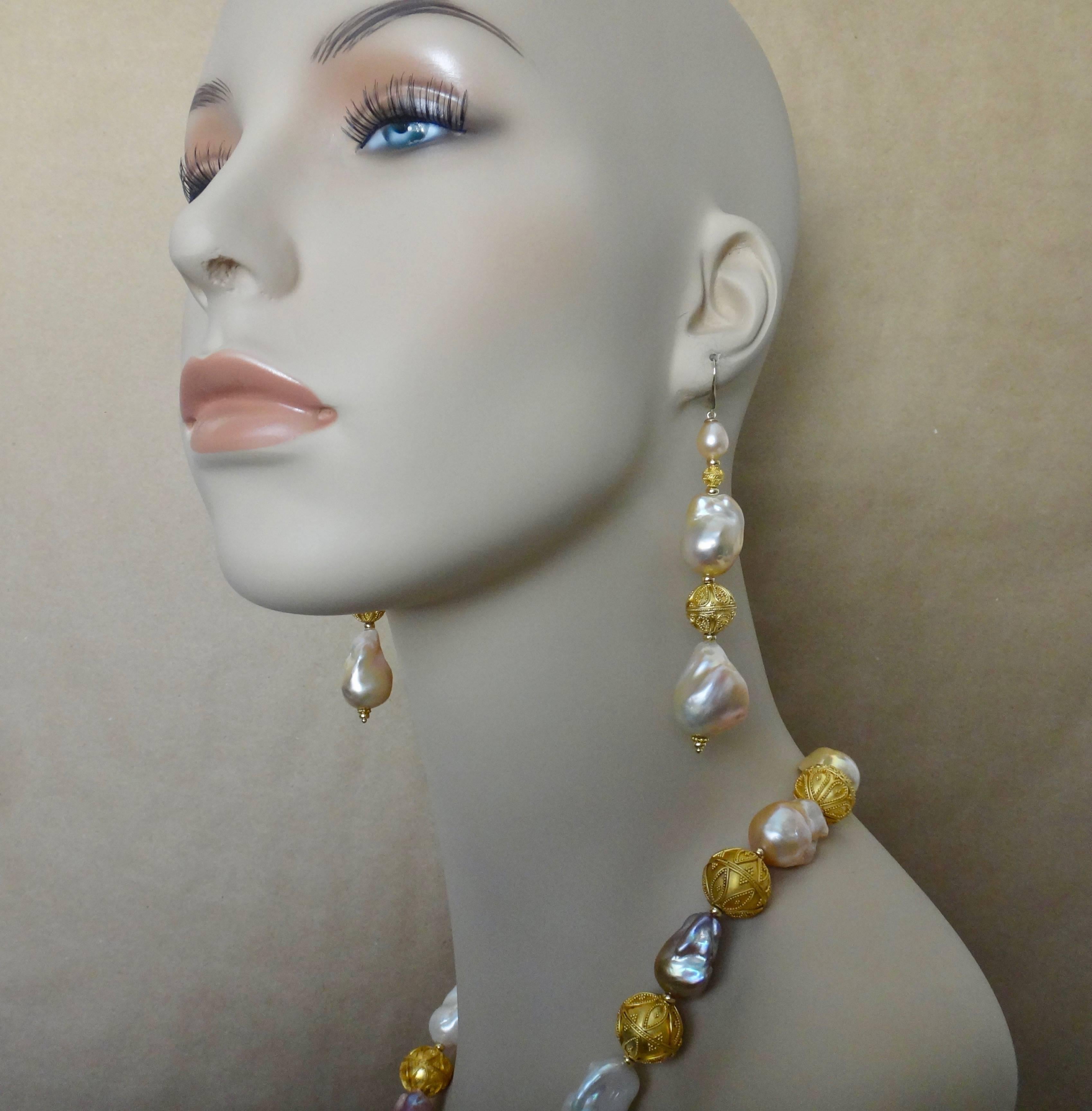 Generously sized cloud pearls are complimented by granulated beads in this bold suite.  The pearls possess rich colors and great luster.  The beads are granulated.  Granulation is an ancient process of jewelry decoration dating back to the