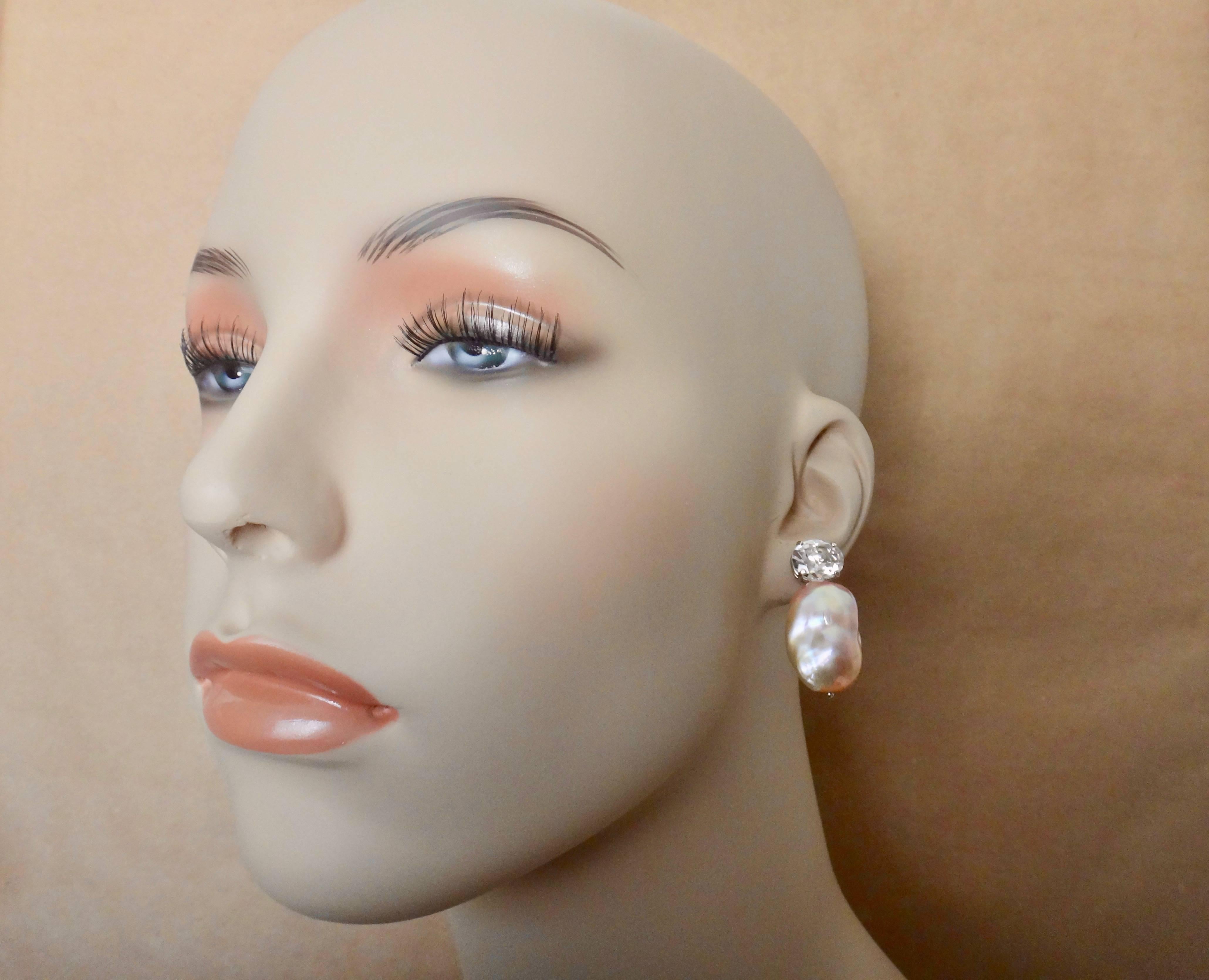 A substantial pair of pink cloud pearls are paired with oval cut platinum topaz in these classic drop earrings.  The pearls possess wonderful color and rich luster.  The gems are set in white gold.  The earrings come with posts and omega clip backs