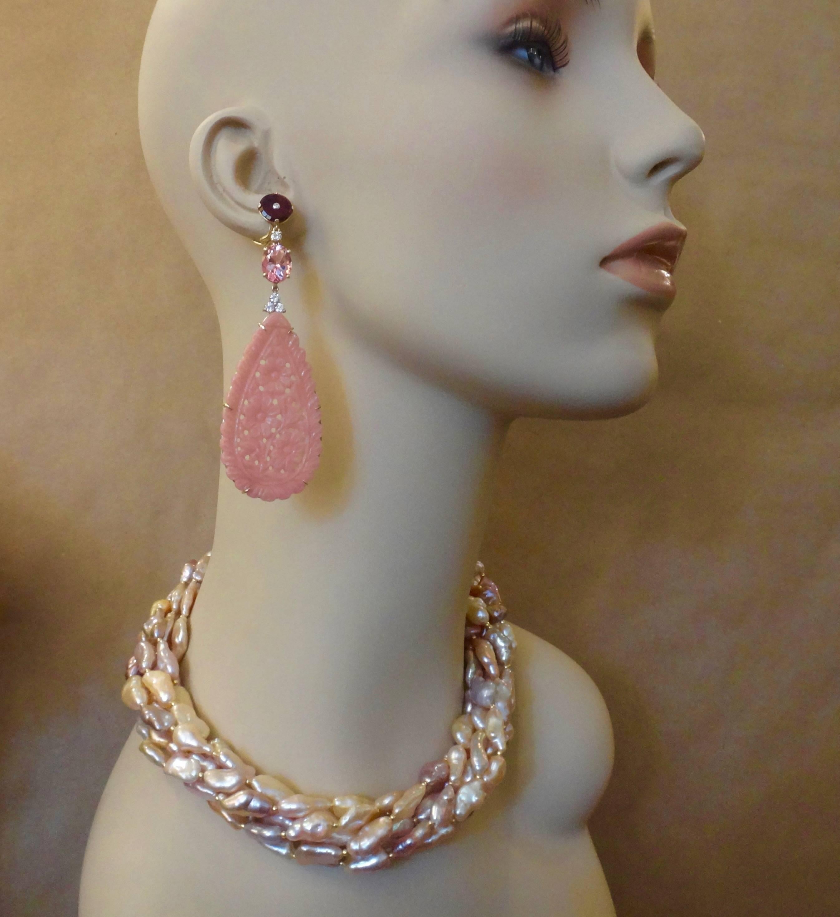 Six strands of oblong shaped freshwater pearls in various shades of pink, mauve and lavender are twisted together to form this torsade necklace.  The pearls possess a bright luster and brilliant sheen.  They are spaced with small gold beads.  The