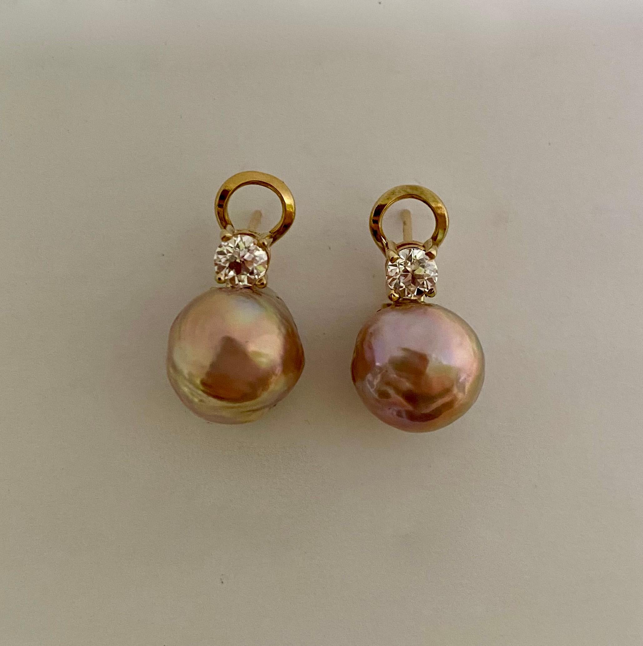 Pink Kasumi pearls are paired with diamonds in these classic drop earrings.  The baroque pearls (origin: Japan) possess a base pink color but their rich luster reflects a range on other colors including green and gold.  The pearls are complimented