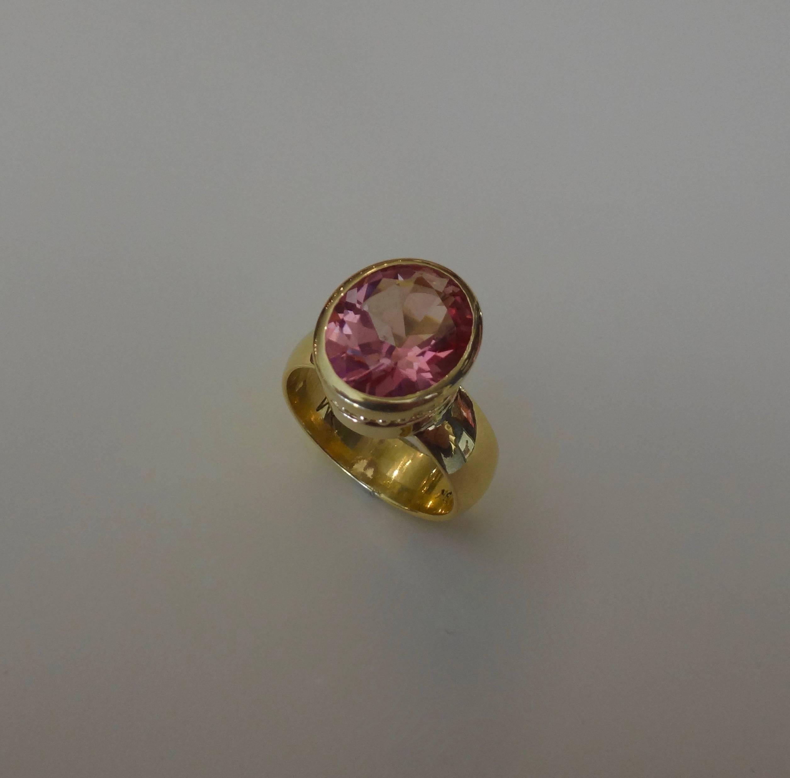 Delicately colored and beautifully cut, a pink topaz is featured in Michael Kneebone's iconic Leah ring.  The gem is set in eighteen karat yellow gold with beaded detail around the bezel.  This ring is lovely when worn alone or may be paired with