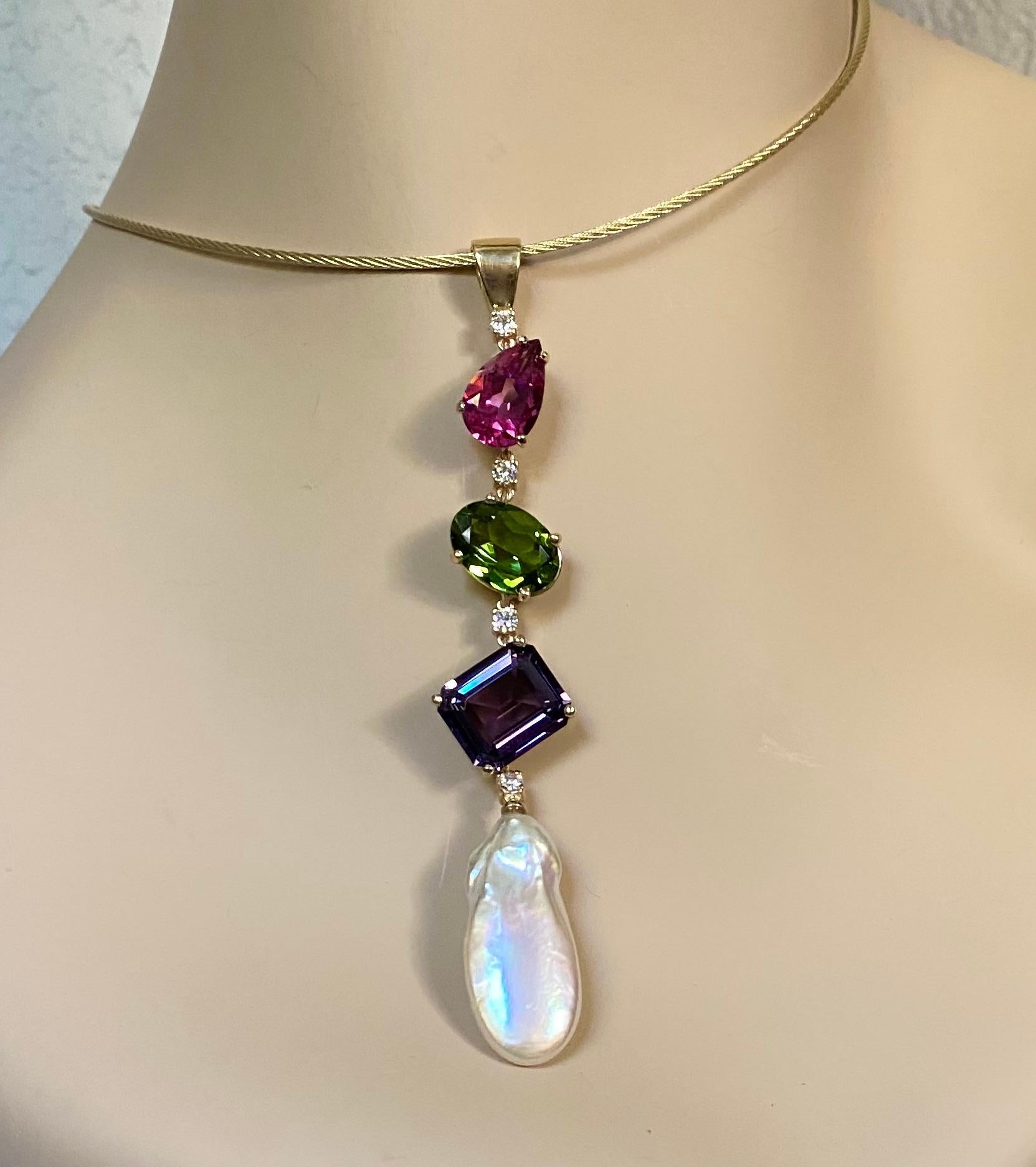 Mixed gemstones along with a baroque pearl and diamonds are offered in this Stiletto pendant.  A brightly colored pear shaped pink topaz and a brilliantly colored oval peridot along with a richly colored emerald cut amethyst are spaced with