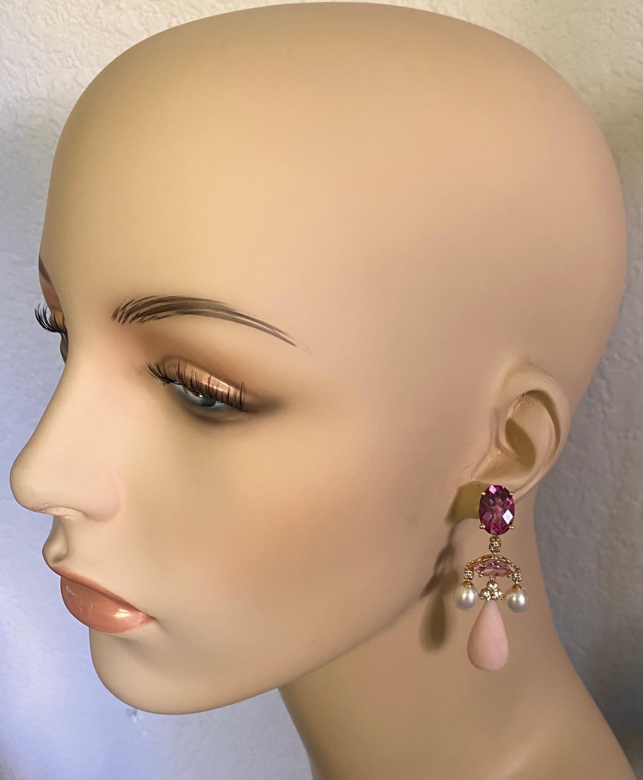 Pink gems are showcased in these elegant chandelier dangle earrings.  Deep pink topaz (origin: Brazil) in oval shape and checkerboard cut tops the composition.  A delicately colored marquise cut pink tourmaline (origin: Mozambique) set horizontally