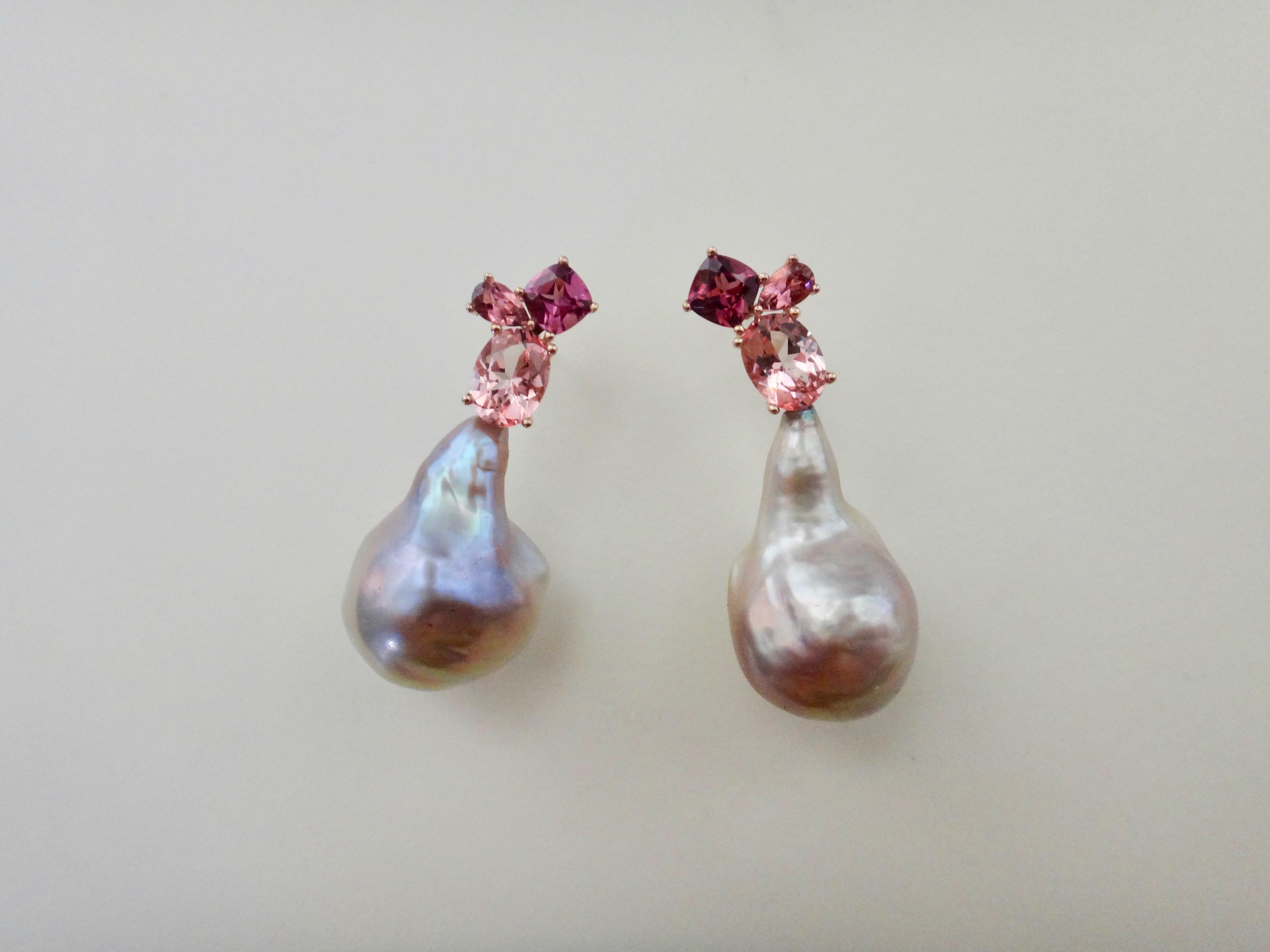 Gathered together are a cushion shaped Rhodolite garnet, pear shaped pink tourmaline and an oval shaped pink topaz in these unique Confetti earrings.  Suspended below each cluster of gems is a large baroque pearl of a pinky-taupe color, both pearls