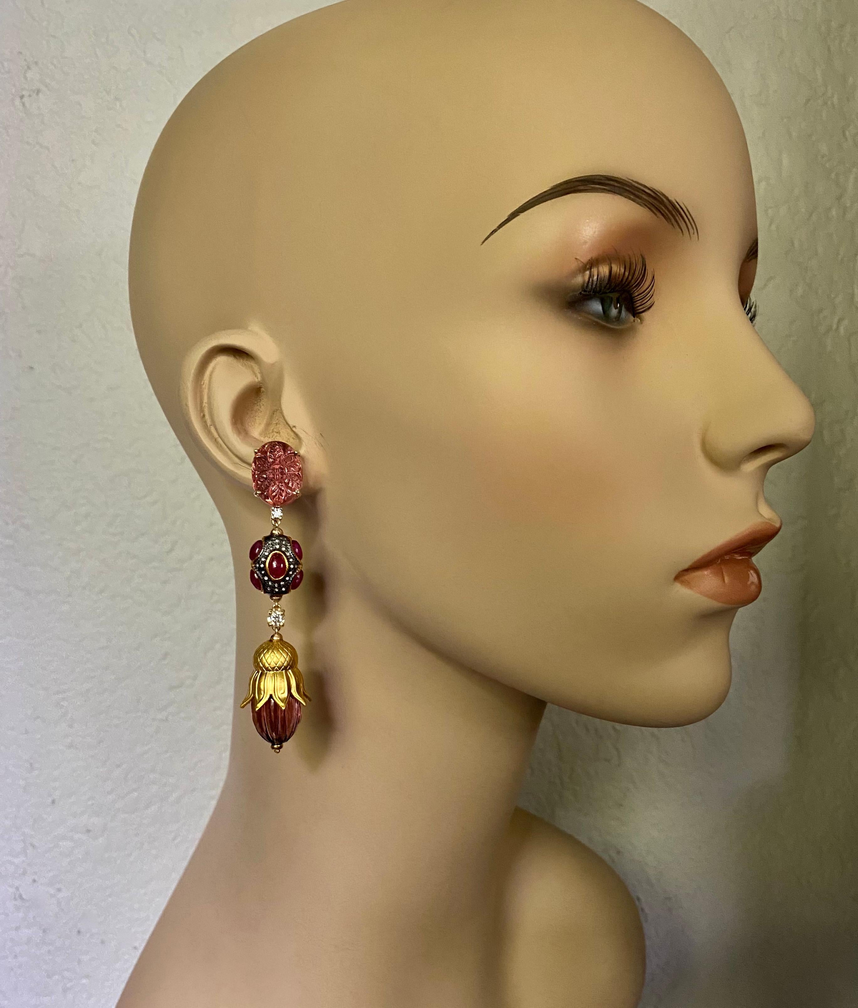 A melange of gemstones form these Mughal style dangle earrings.  Carved pink tourmalines (origin: Brazil) in floral and melon carved forms are complimented by beads (origin: India) set with cabochon rubies and pave diamonds set in blackened silver. 