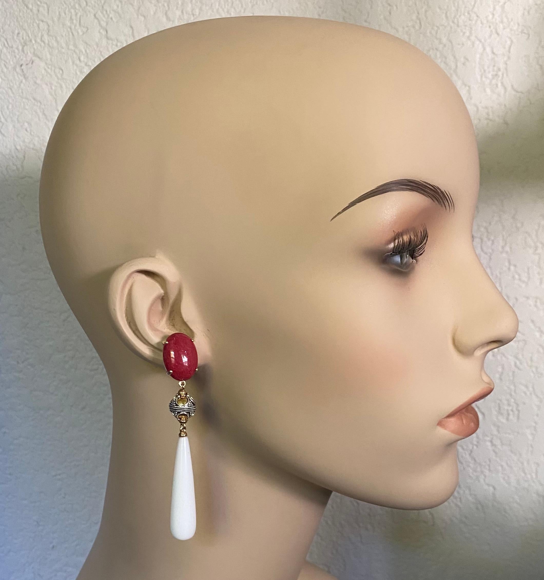 Red coral is paired with white chalcedony in these bold dangle earrings.  The coral (origin: Philippines) is a deep red color.  They are perfectly matched, cut and polished.  The drops are carved from white chalcedony.  They are beautifully matched,