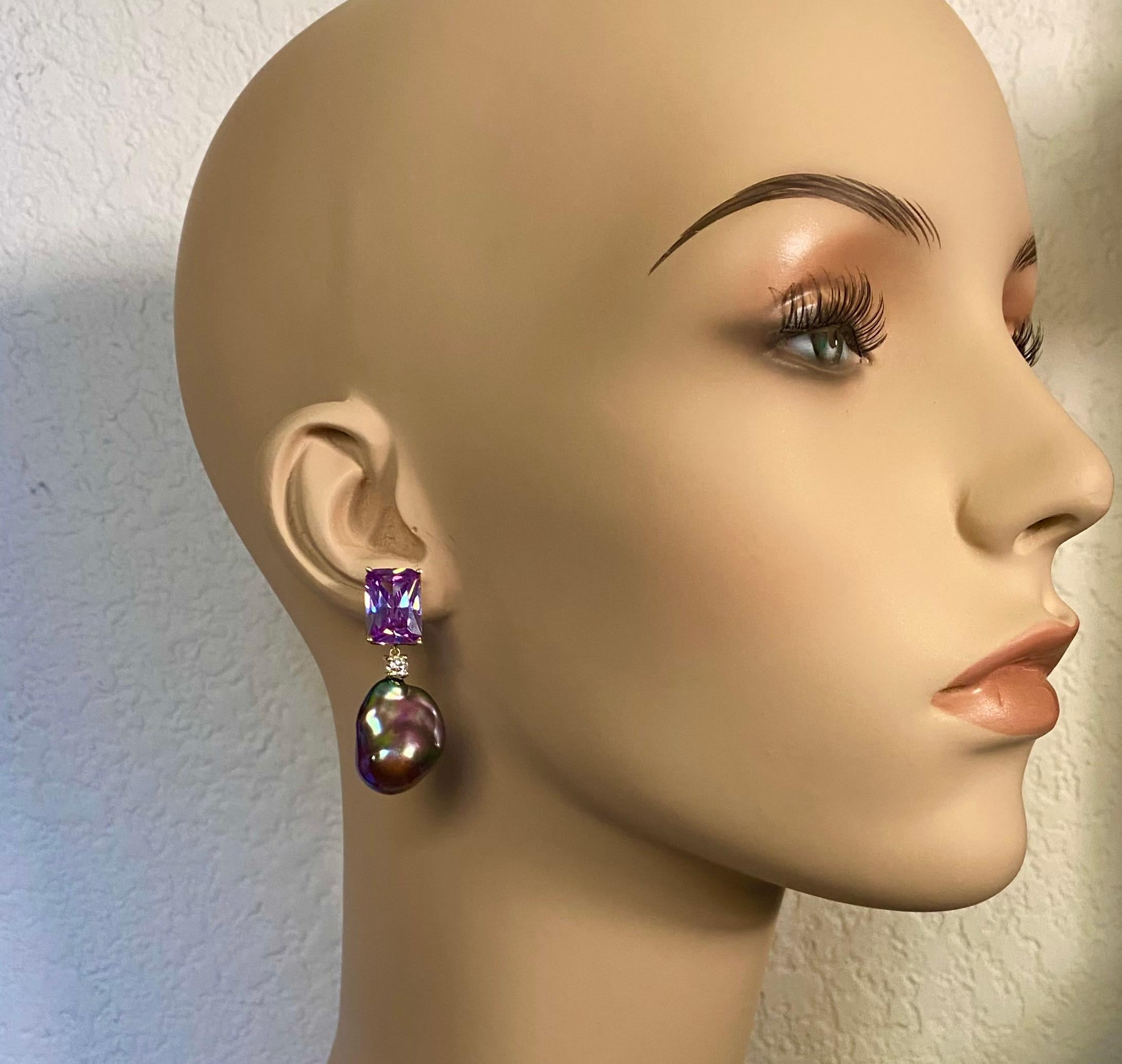 Rose de France amethyst is paired with black baroque pearls in these utterly elegant dangle earrings.  The amethyst (origin: Brazil) are rectangular in shape and expertly cut in a unique scissor pattern generating maximum brilliance.  The ginormous