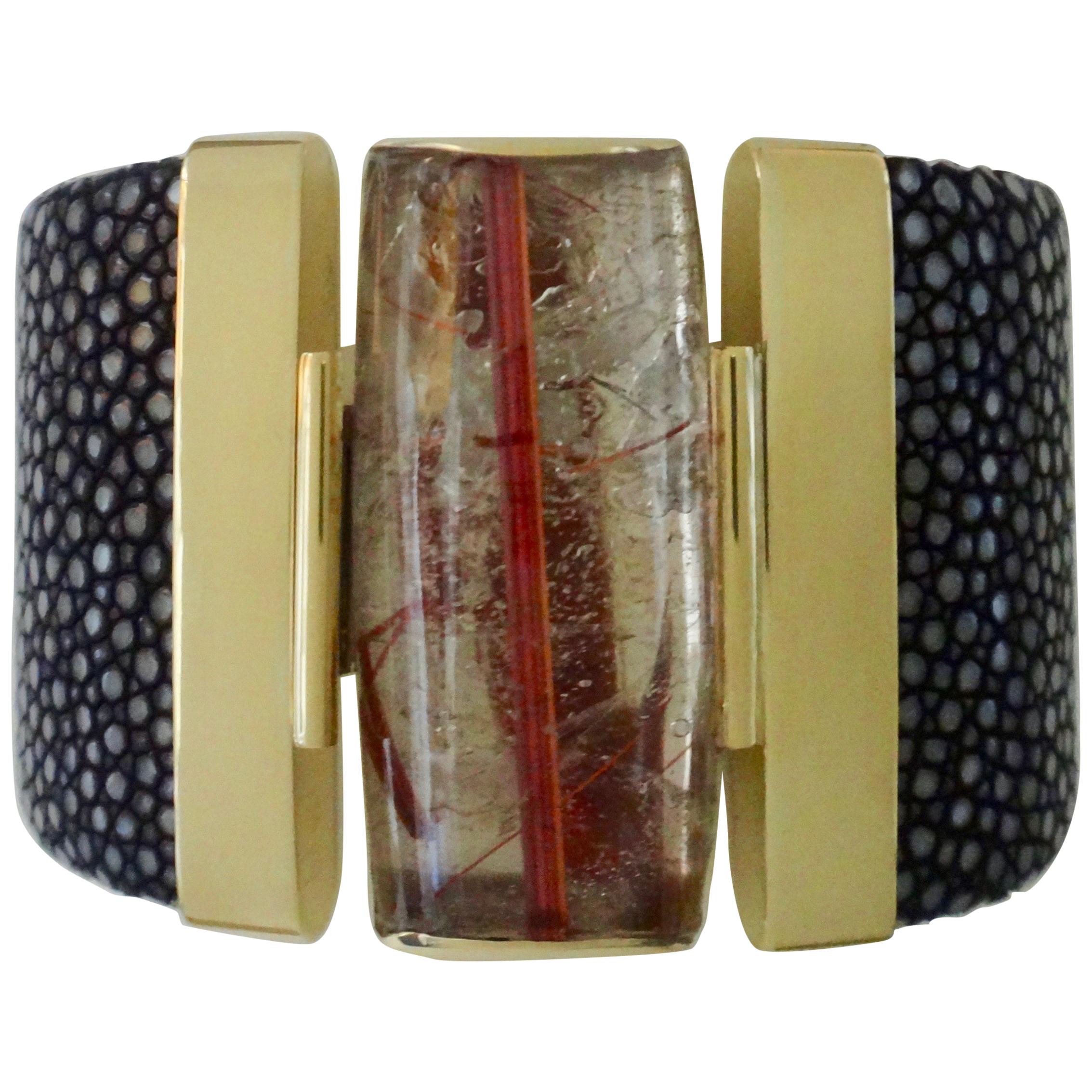An extraordinary specimen of rutilated quartz (origin: Brazil) is featured in this bold cuff bracelet.  Rutilated quartz is a member of a vast family of gems including amethyst and citrine.   In this example, the quartz possesses inclusions of