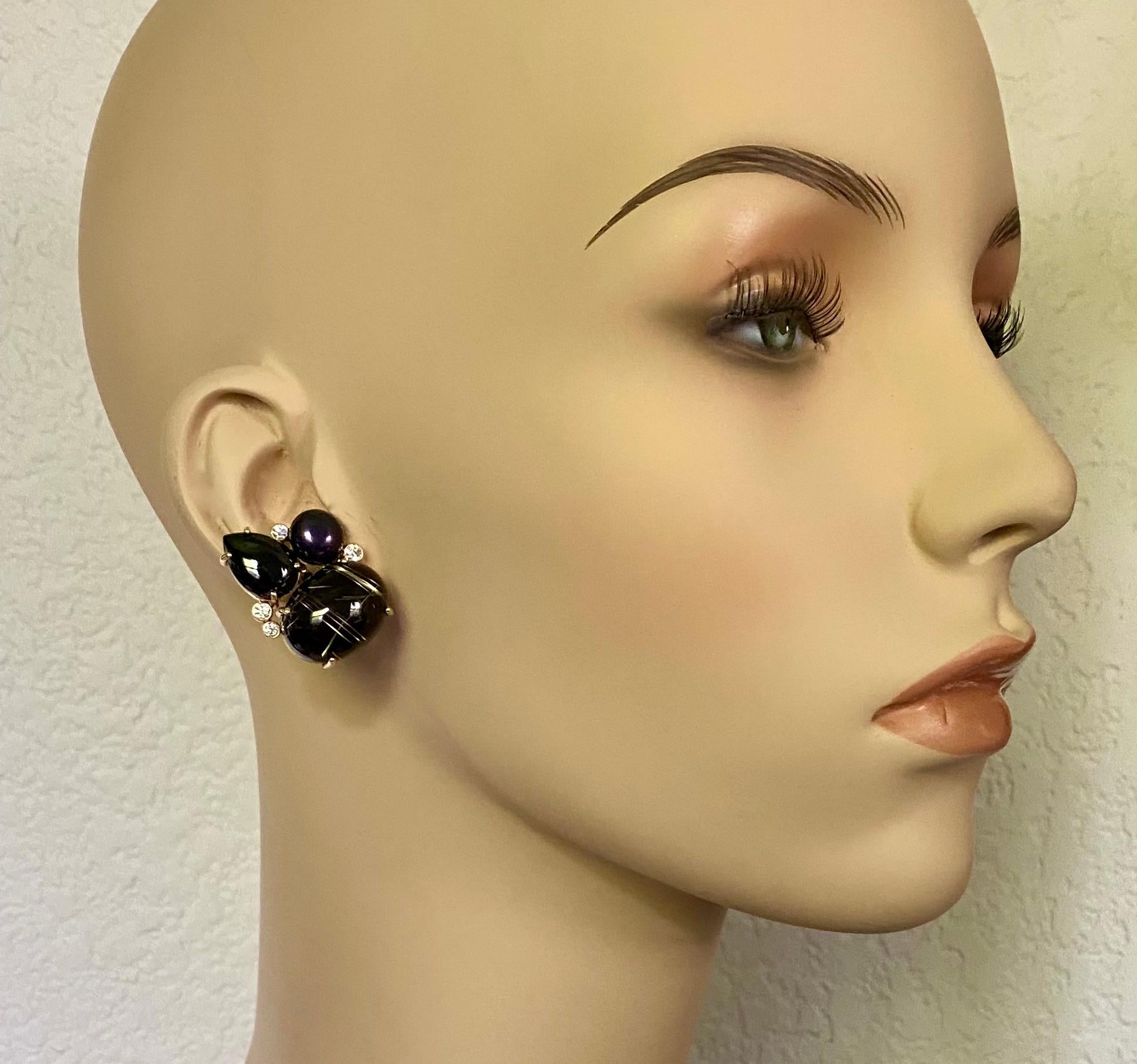 Rutilated quartz is paired with black spinel, white diamonds and black pearls in these bold cluster earrings.  Rutilated quartz (origin: Brazil) is a gem with rods of gold colored titanium shot thorough.  The base material is clear.  In this case,