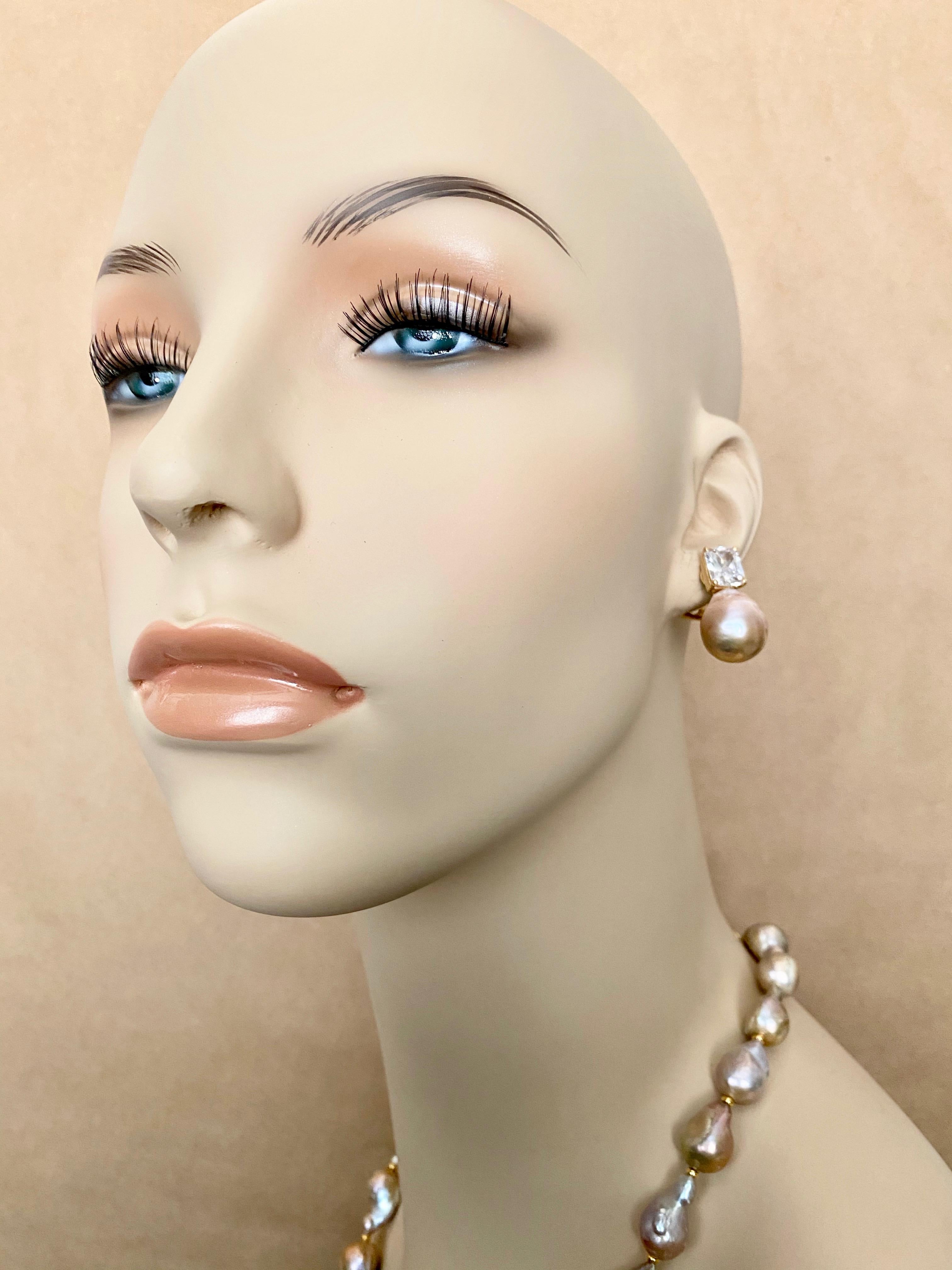 Flame Ball pearls (origin: China) comprise this pearl necklace paired with matching pearl and silver sapphire earring to form this chic suite.  The pearls are gray in color with rose tones.  They are very baroque in shape and have beautiful luster. 