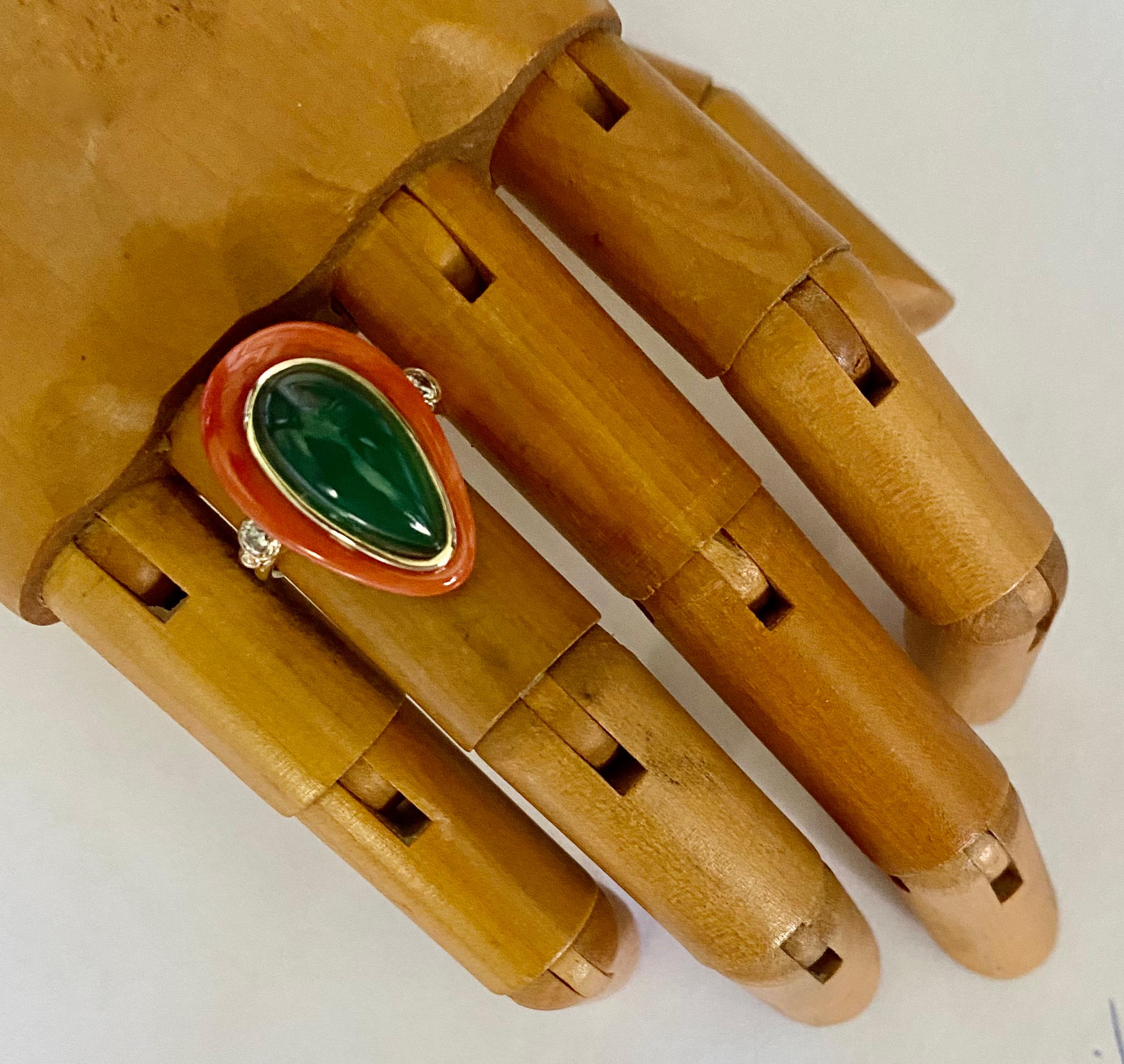 A dynamic color combination of peach and green are featured in this elegant cocktail ring.  The peach color comes in the form of Satsuma coral (origin: Japan).  The coral has been carved into a drop shape.  It has been polished to a glass like