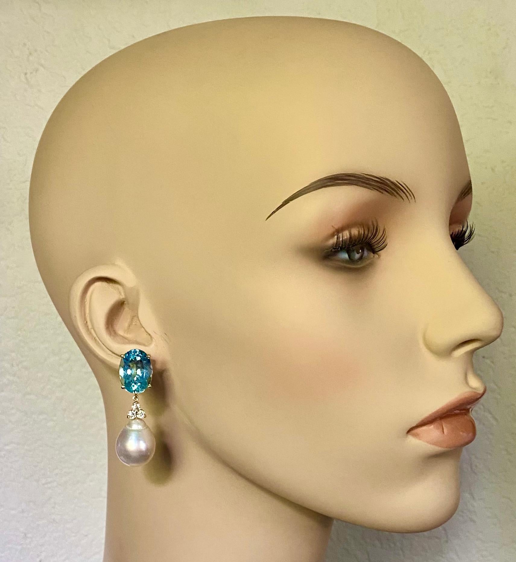 Sky blue topaz are paired with South Seas pearls in these elegant dangle earrings.  The topaz (origin: Brazil) are oval cut, beautifully faceted and well matched.  The pearls are from the firm of Paspaley, the premier cultivator of Australian  South