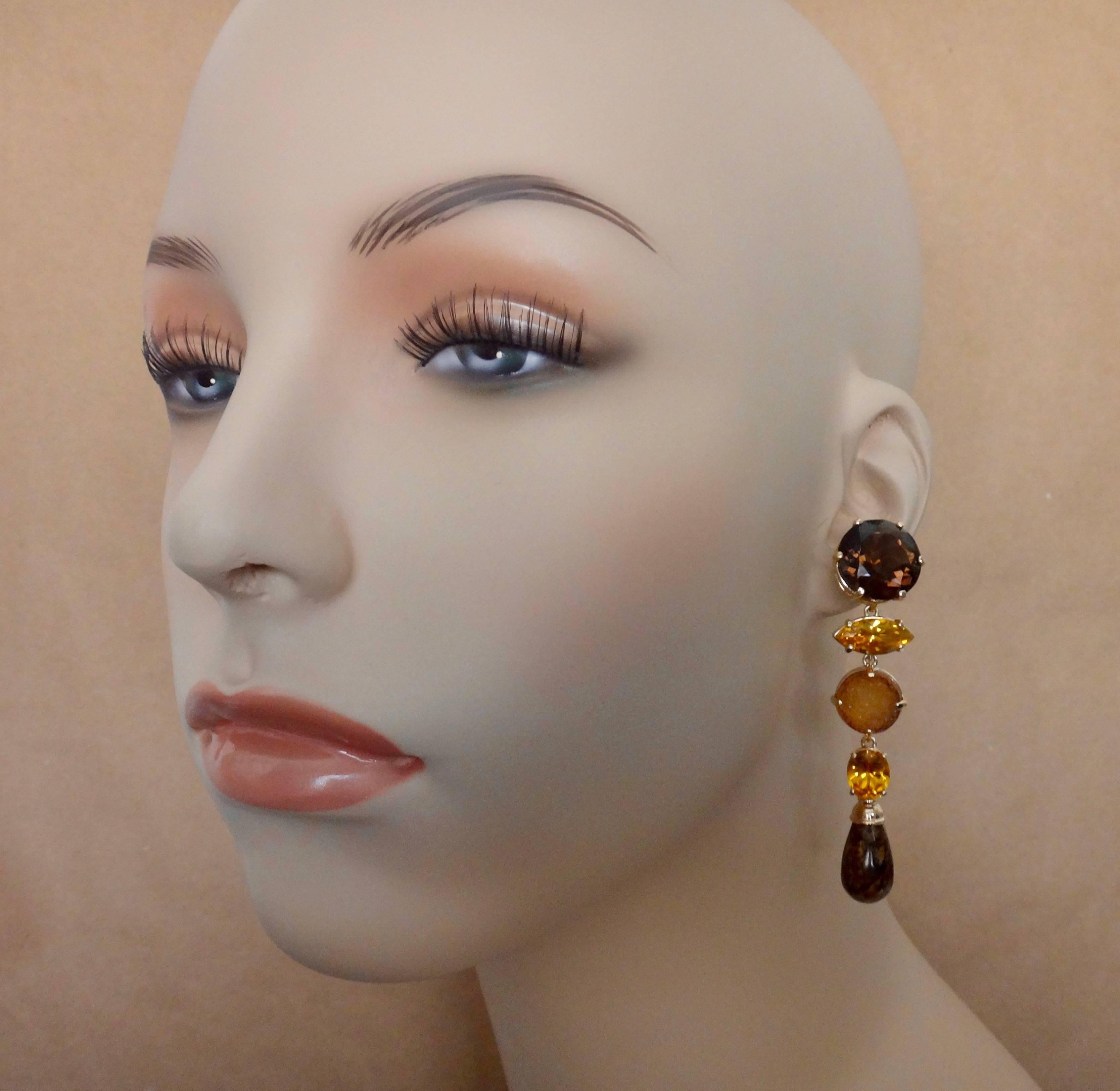A composition of variously shaped smokey quartz, citrine, drusy quartz and bronzite constitute these bold dangle earrings.  Dress them up or dress them down.  The warm tones of the gems are perfect on so many skin tones.  The earrings come with
