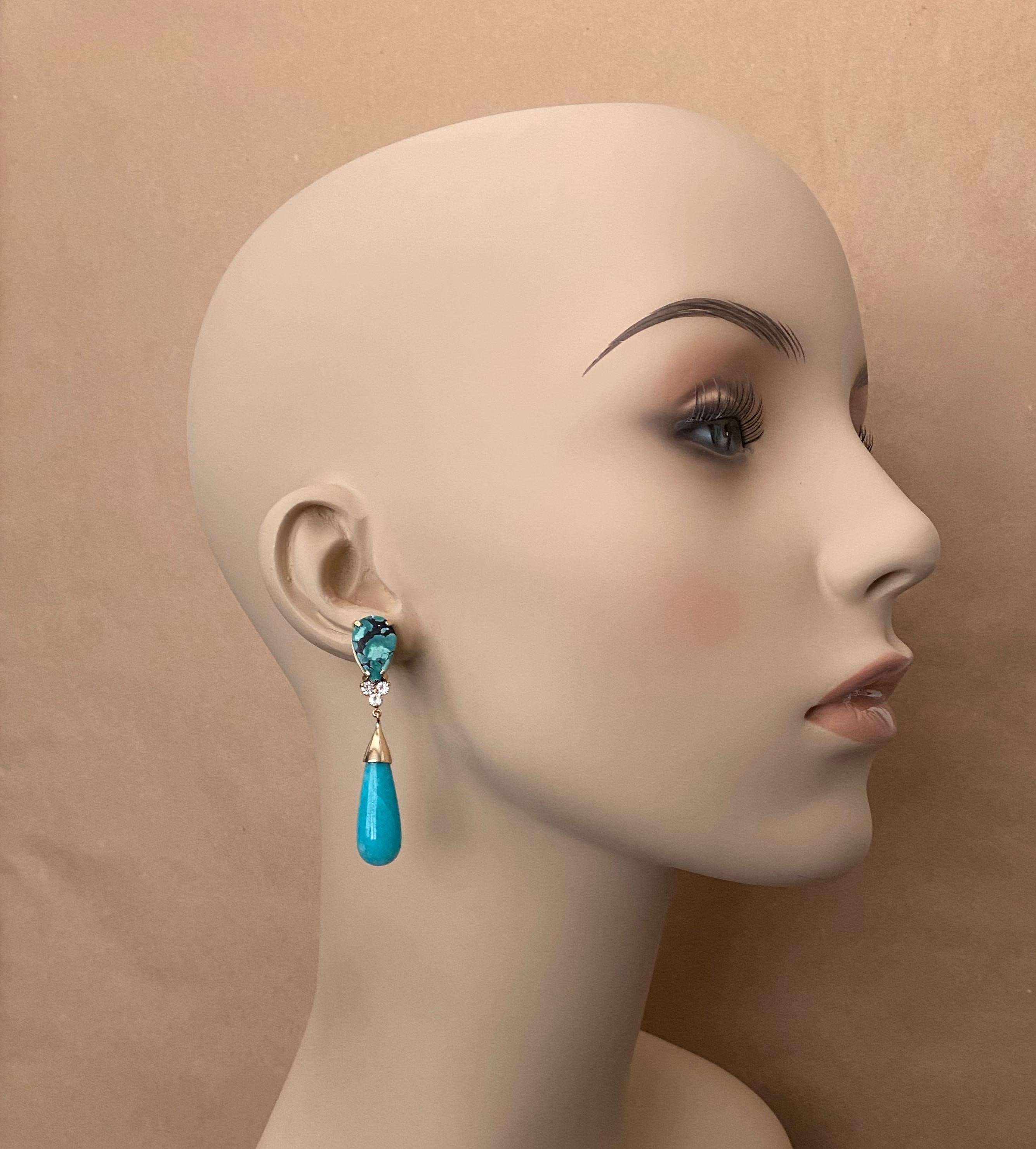 Tibetan turquoise is paired with amazonite in these graceful dangle earrings.  The turquoise is richly colored from dark to light with black matrix and very well matched.  The amazonite (origin: Brazil) is a fine turquoise color and is very well