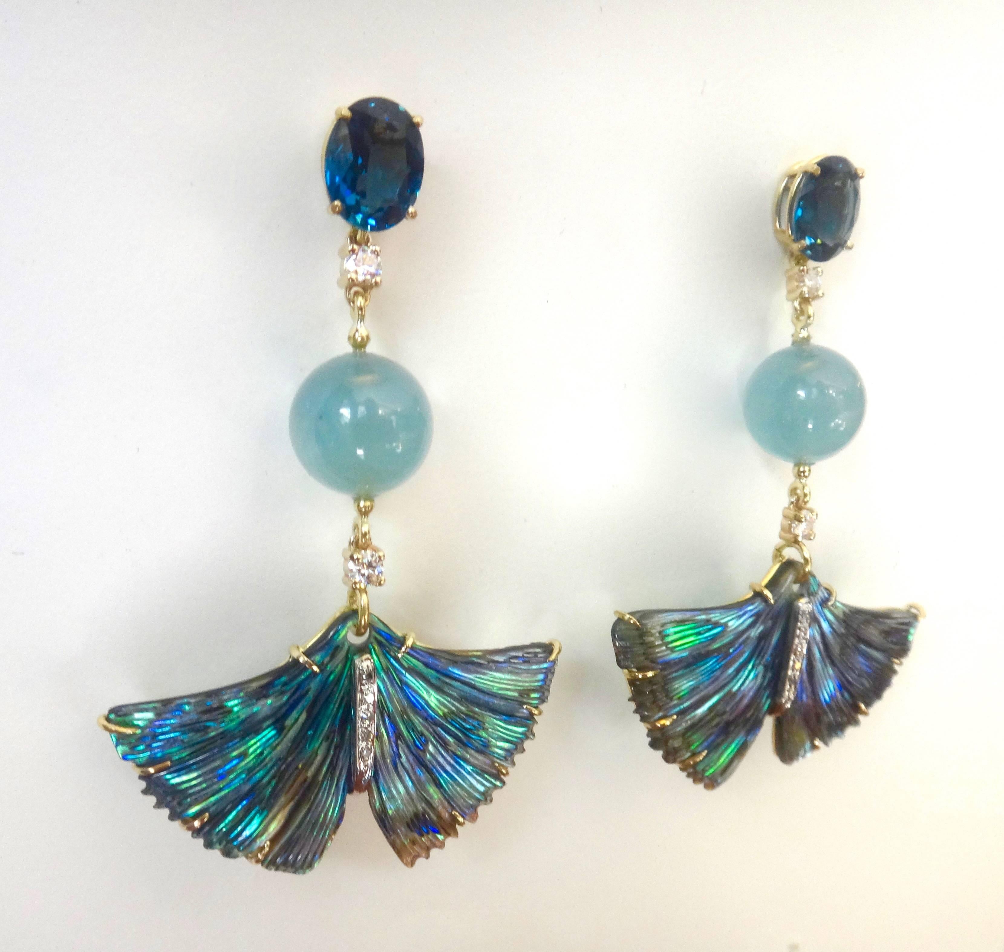 Carved abalone shell in the form of ginkgo leaves are featured in these dangle earrings.  The shades of rich blues in the shell are complimented by faceted London blue topaz, aquamarine beads and white diamonds.  All set in hand fabricated 18k