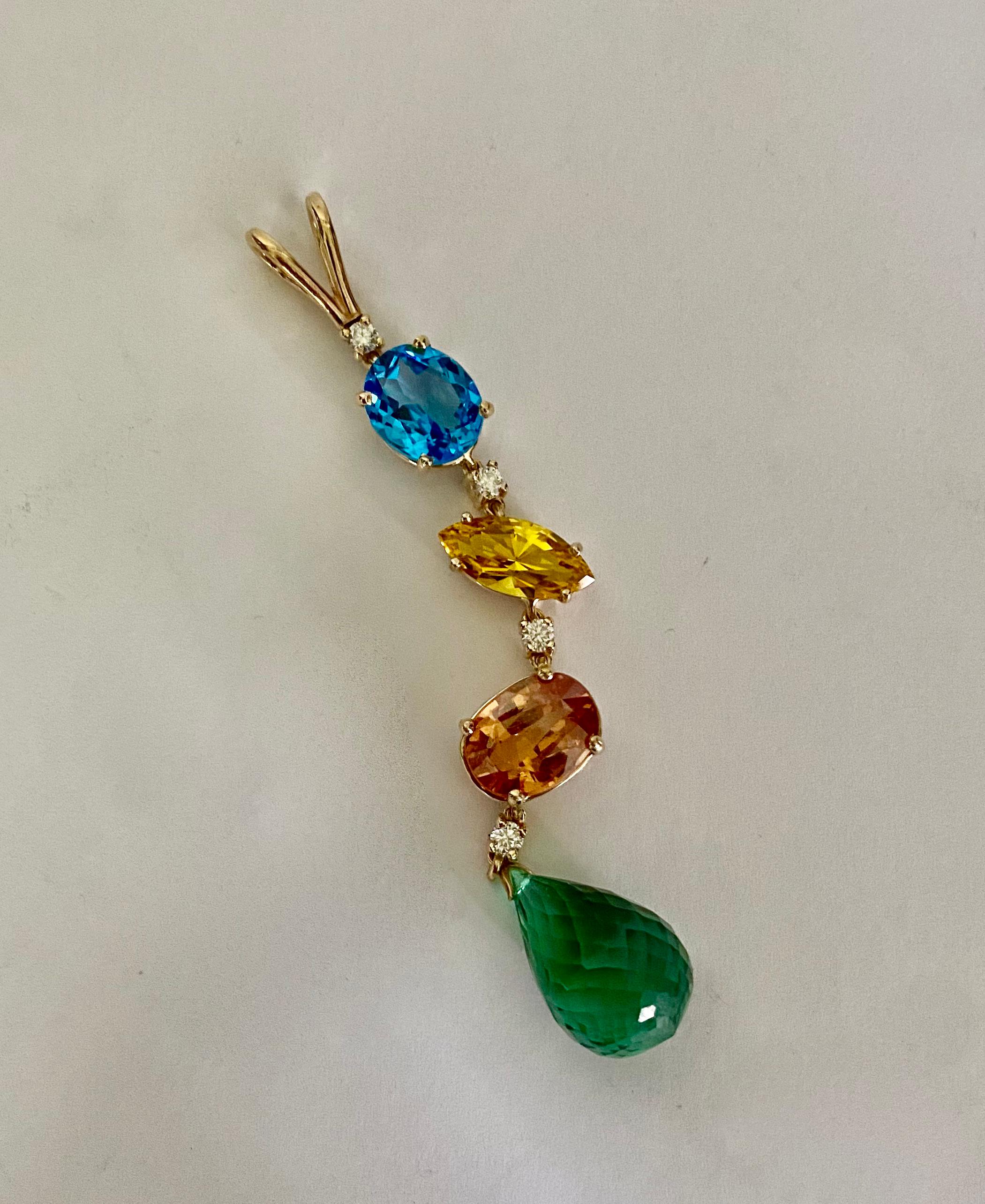 A melange of gemstones forms this dramatic Stiletto pendant.  Swiss blue topaz, citrine and orange topaz in a variety of shapes are spaced with white diamonds.  All the gems originate from Brazil.  They are all well cut and polished.  The