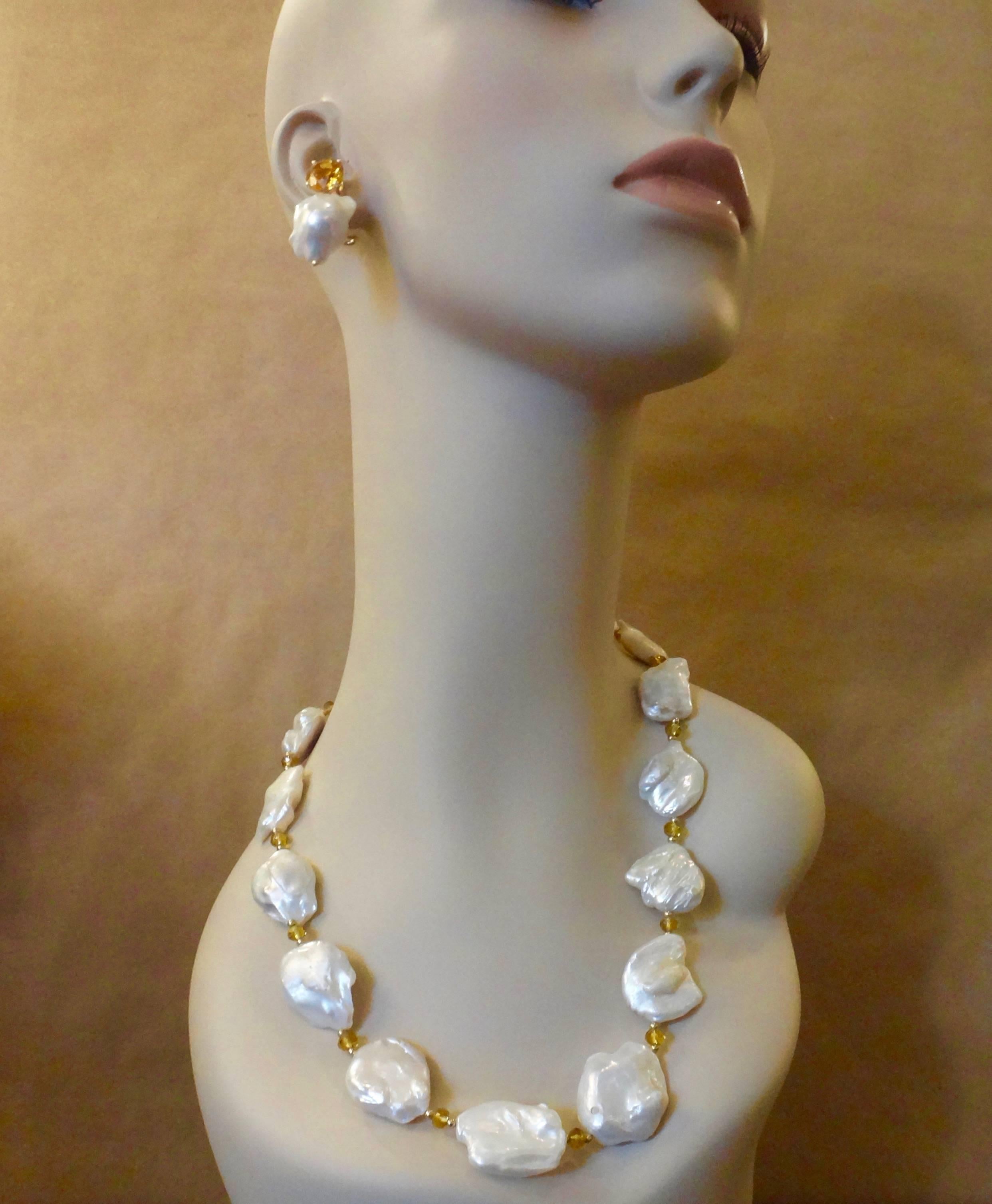 Fifteen giant (up to 40mm) white Keshi pearls form this striking necklace.  The lustrous baroque pearls are spaced with golden citrine rondelles and small gold beads.  The necklace is finished with a vermeil hook and eye clasp for an easy on and