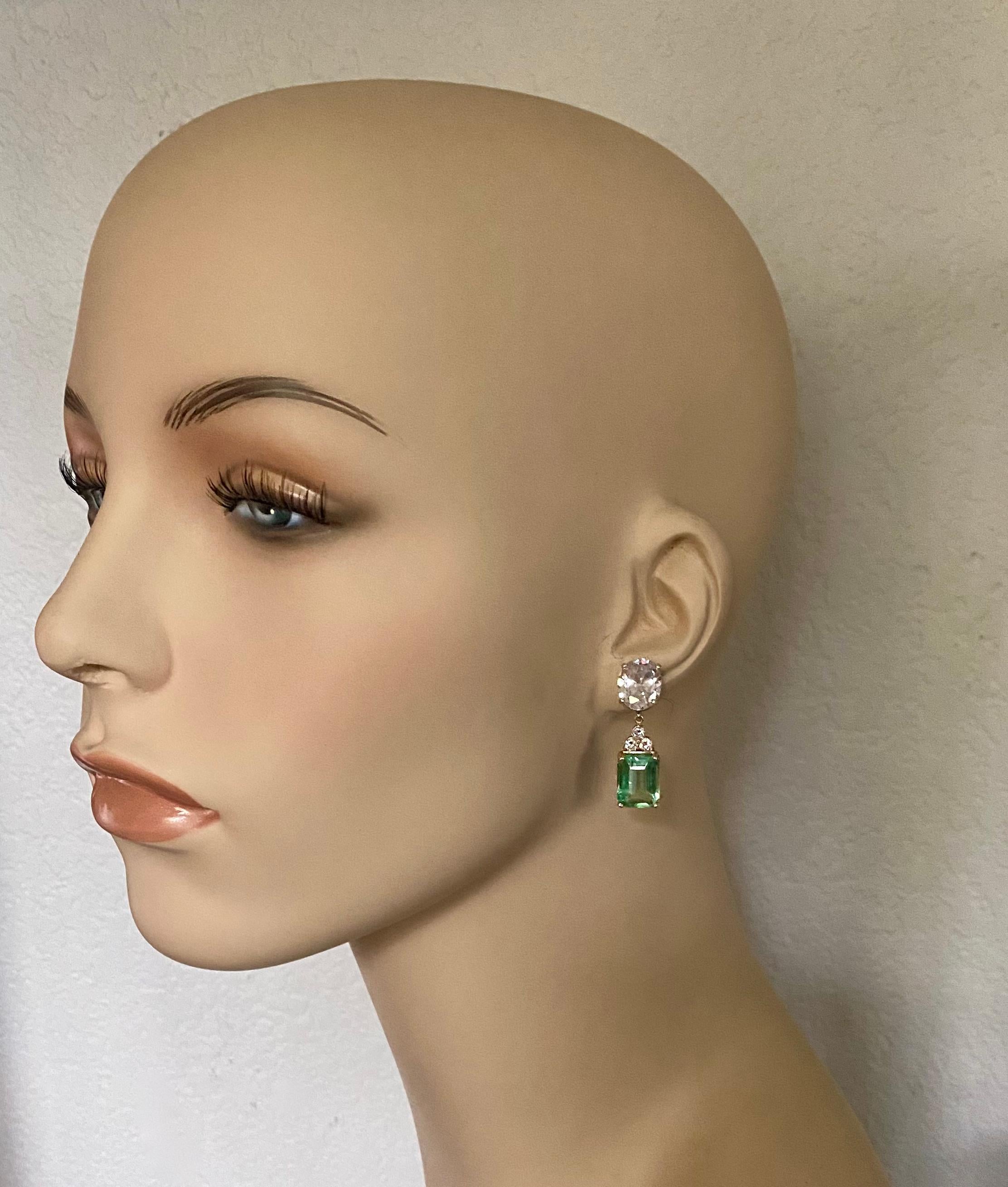 Green beryl is featured in these sophisticated dangle earrings.  Oval cut white sapphires (origin: Thailand) anchor the compositions.  The beryl (origin: Brazil) has been fashioned into emerald cut shapes and are a delicate mint green color.  White