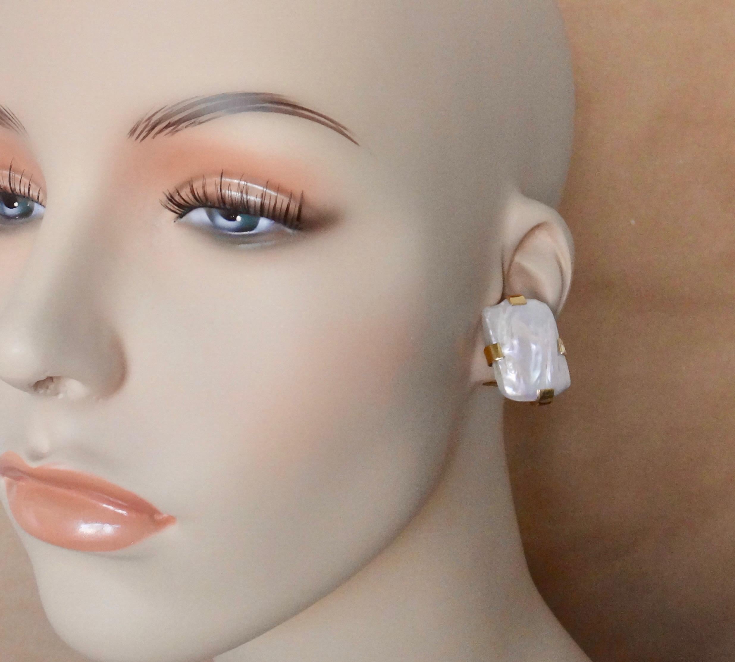 Extra large tile pearls are set in 18k yellow gold button earrings. The bright, white baroque pearls have exceptional luster reflecting pinks, blues and greens.  Four large tabs hold the pearls in place within the handmade mounts.  These earrings