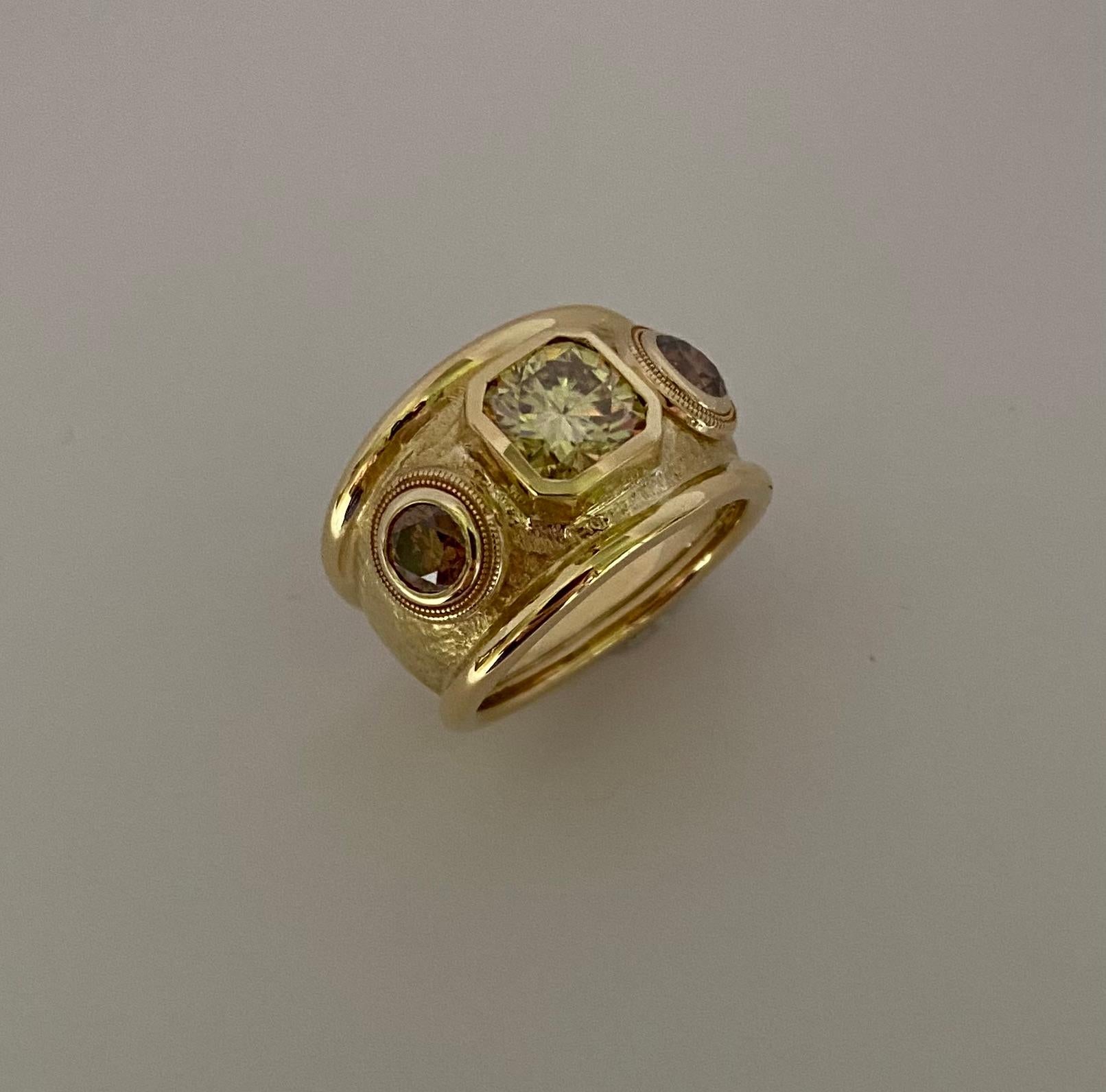 A yellow diamond is complimented by cognac diamonds in this classic bombe style ring.  The center diamond is a light fancy yellow square cut diamond of 1.92 carats.  The VS clarity gem is very well cut and very flashy.  The diamond is flanked by a