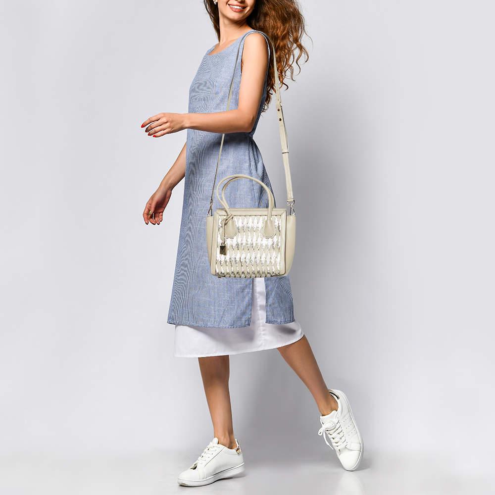 Created from high quality materials  this tote is enriched with functional and classic elements. It can be carried around conveniently  and its interior is perfectly sized to keep your belongings with ease.