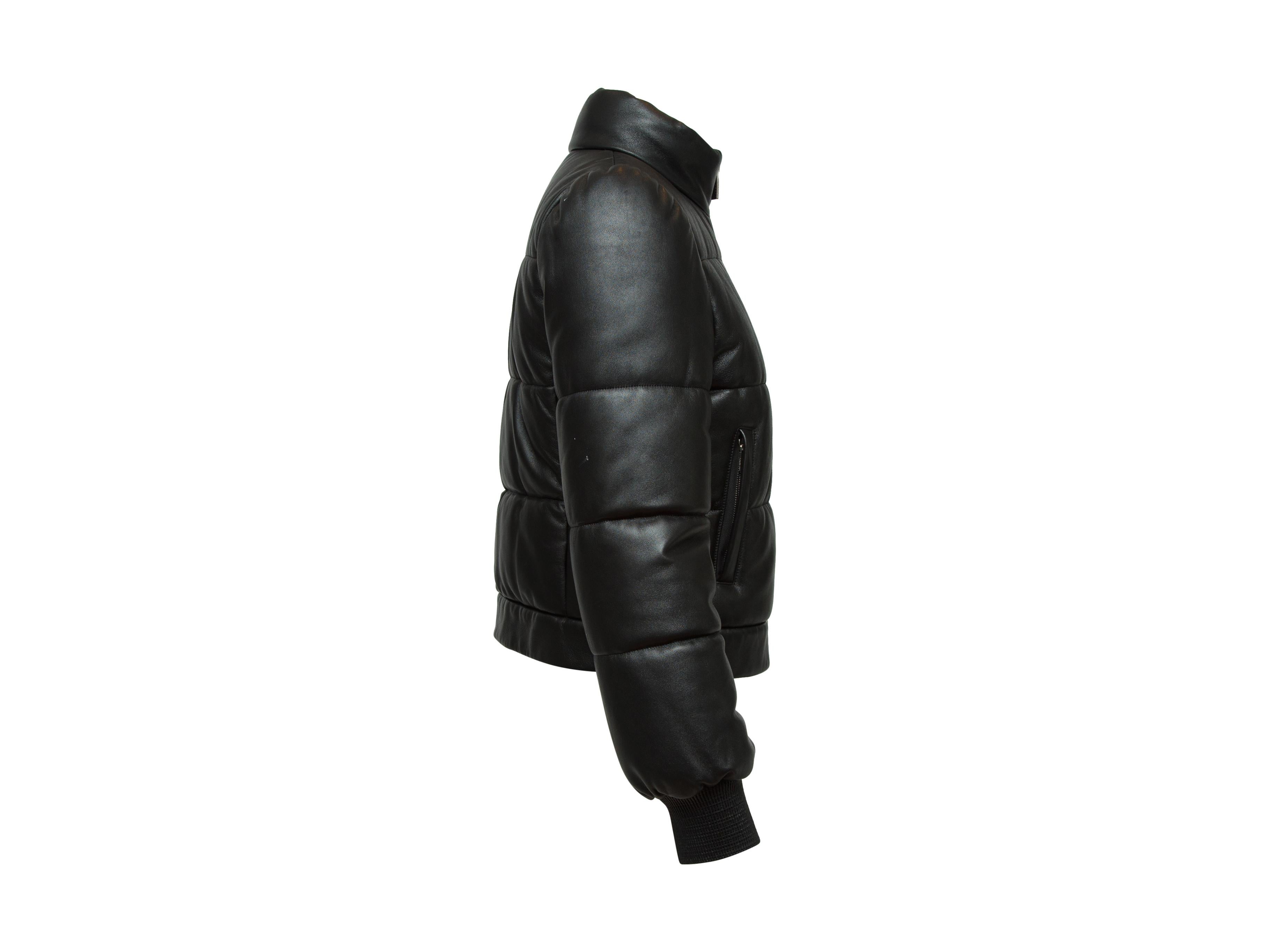 Product details: Black leather puffer jacket by Michael Kors Collection. Mock neck. Dual pockets. Zip closure at front. 30