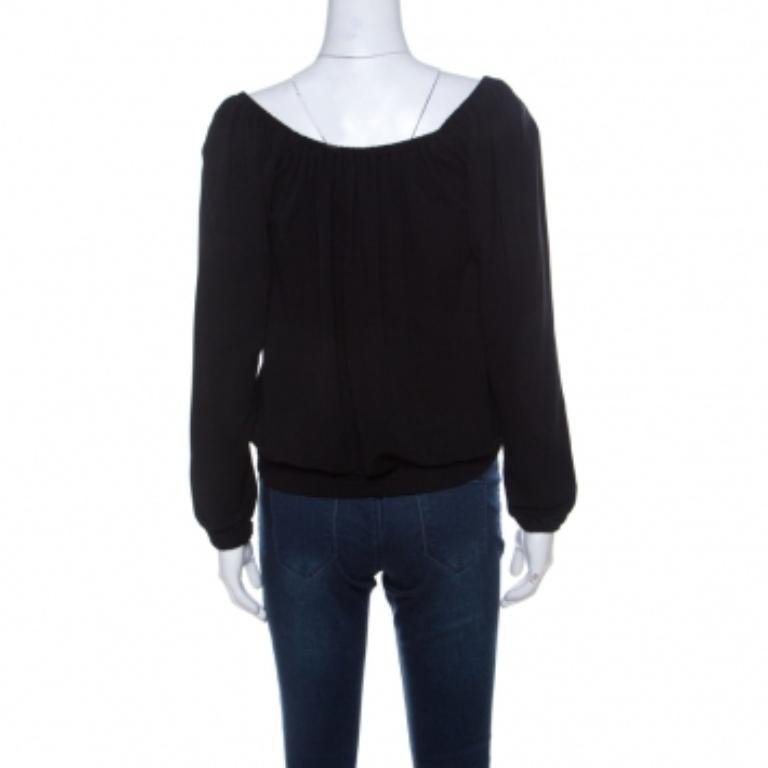 Michael Kors brings to you this black top that can be paired with almost anything in your dresser. This top is a definitive fashion choice that features long sleeves and a drawstring tie detail. It is easy to style and can be worn as an off-shoulder.