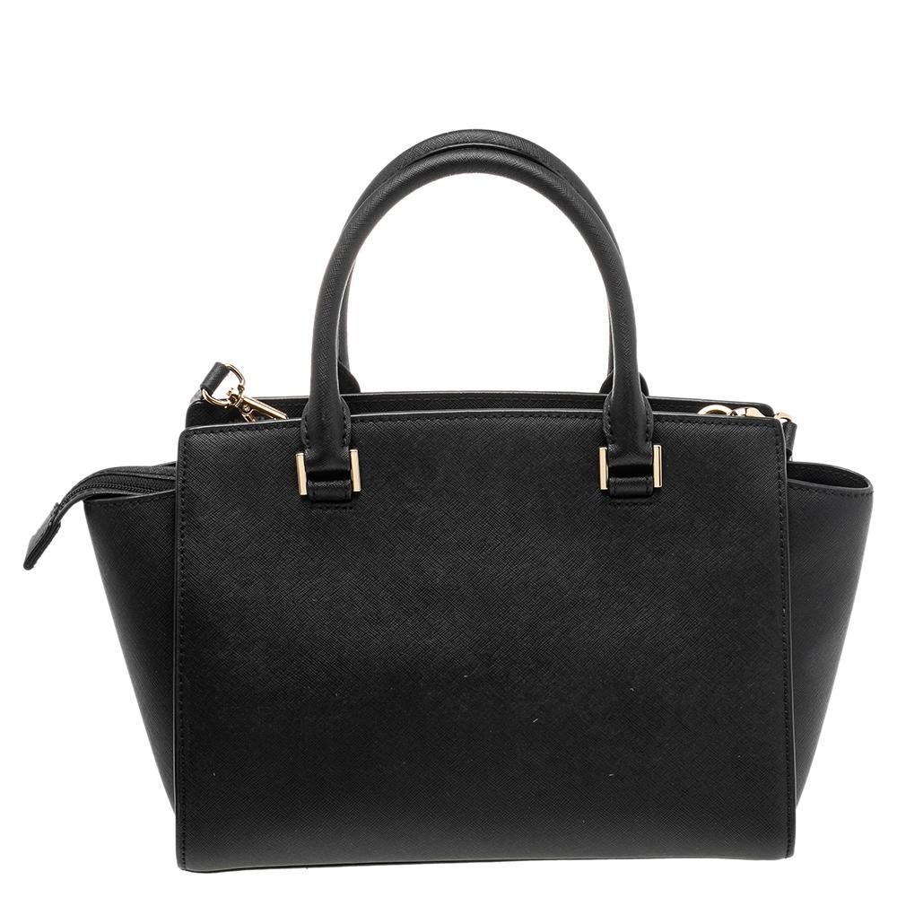 
Carry this gorgeous Selma tote by Michael Kors to all your outings. Crafted from leather, the bag features dual top handles and protective metal feet at the bottom. It has a spacious fabric-lined interior that will hold all your daily necessities.
