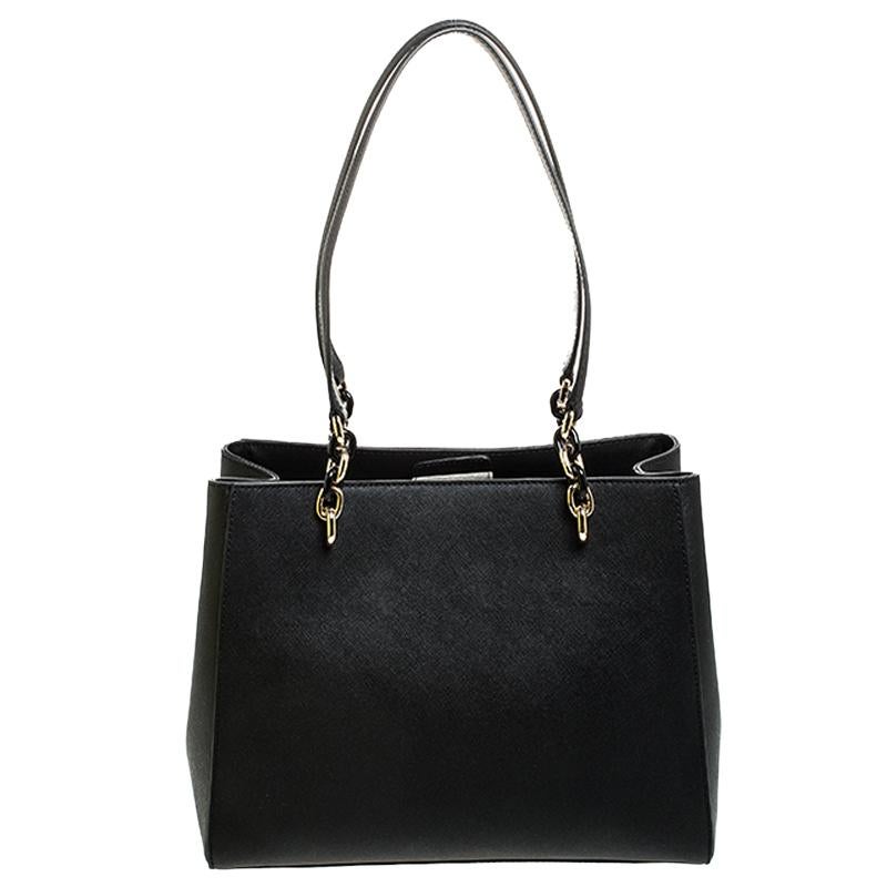 This lovely Sofia tote by Michael Kors is stunning. Crafted from quality leather, it comes in a lovely shade of black. It features dual handles, a nylon-lined interior with more than enough space for your essentials. It is finished with the MK logo