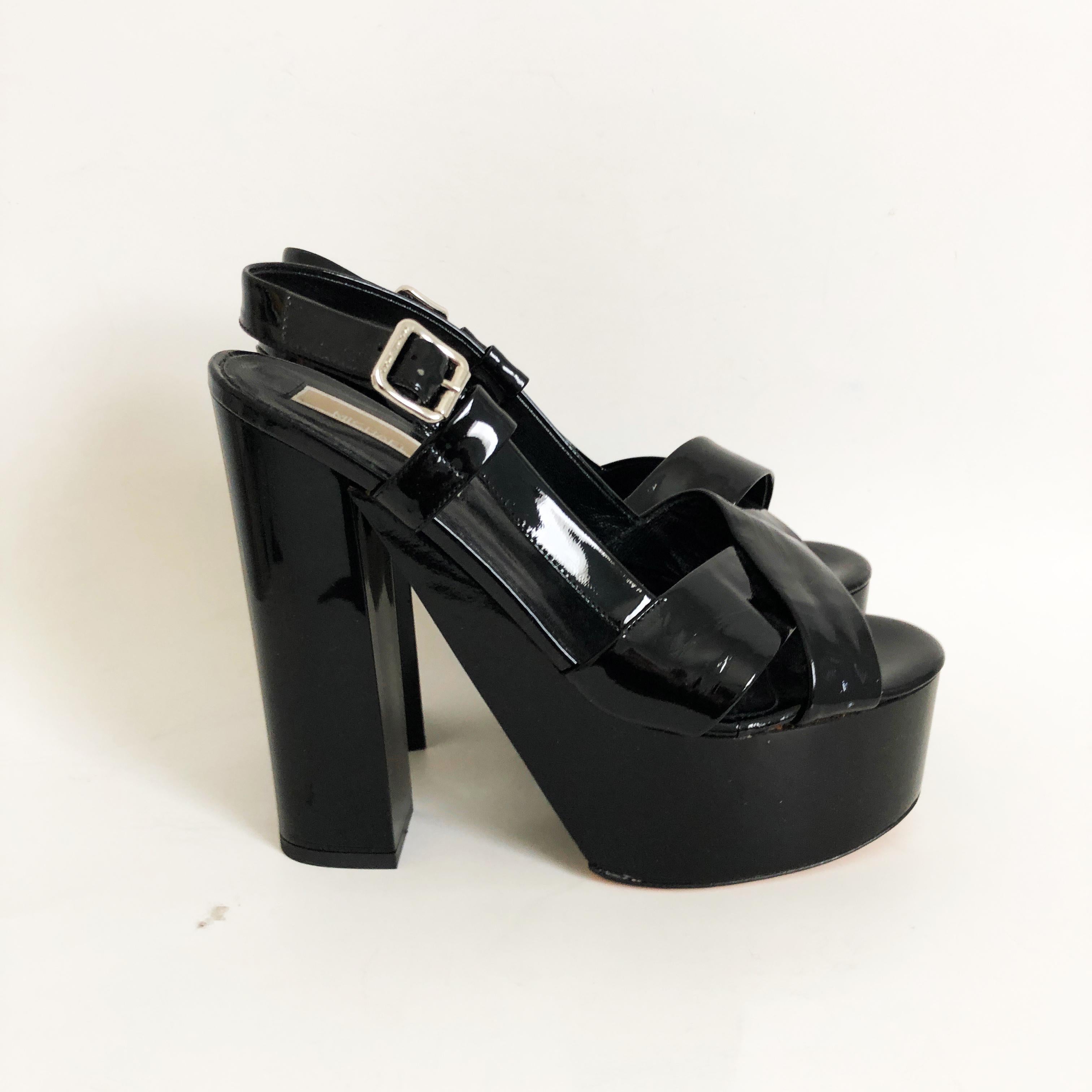 Authentic, preowned Michael Kors Black Patent Platform Sandals, size 7.5.  Definitely a retro Studio 54 vibe with these platforms!

Black patent leather.  Made in Italy.  Heels measure approximately 6in H, platforms measure 2in H. New old stock,