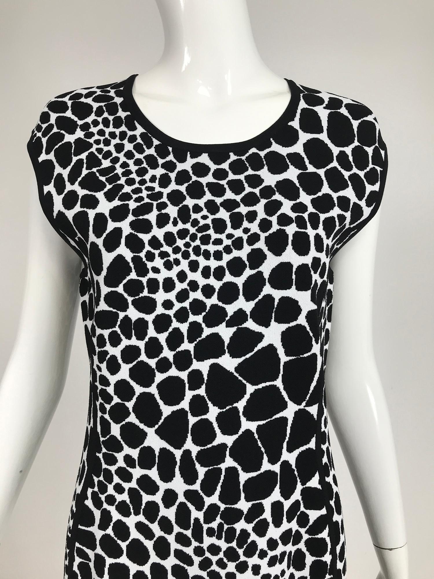 Michael Kors black & white knit stretch animal print dress. Pull on knit dress with a scoop neckline and cap sleeves and fitted silhouette. Princess seams and hem are highlighted in black cord ribbon knit. Unlined dress looks barely, if ever worn.